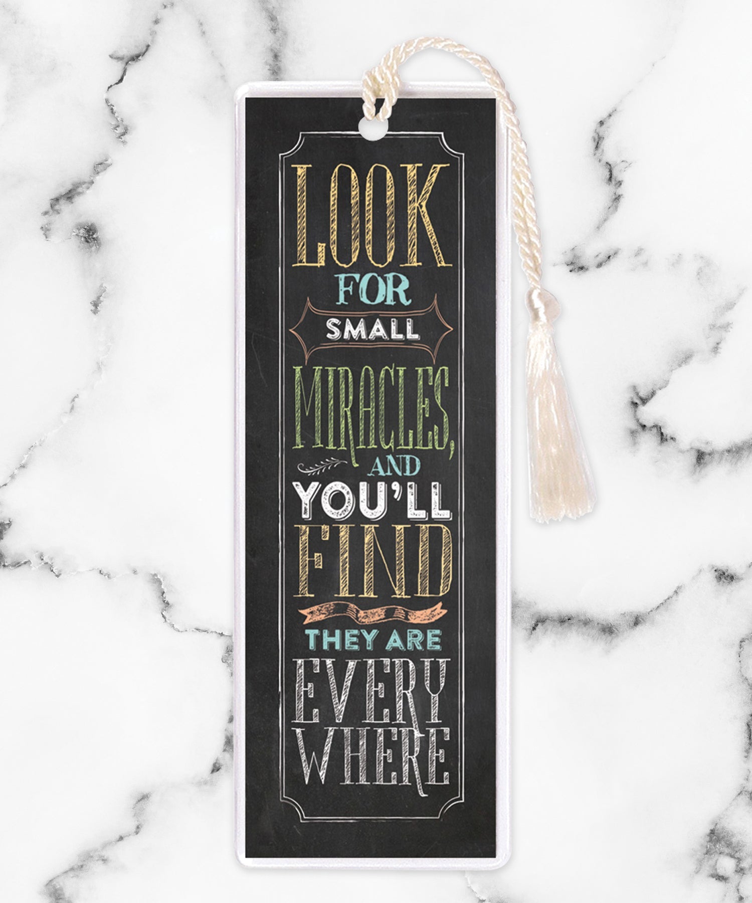 An elegant double-sided bookmark, Look For Small Miracles, is protected by a clear vinyl sleeve and finished with a tassel.