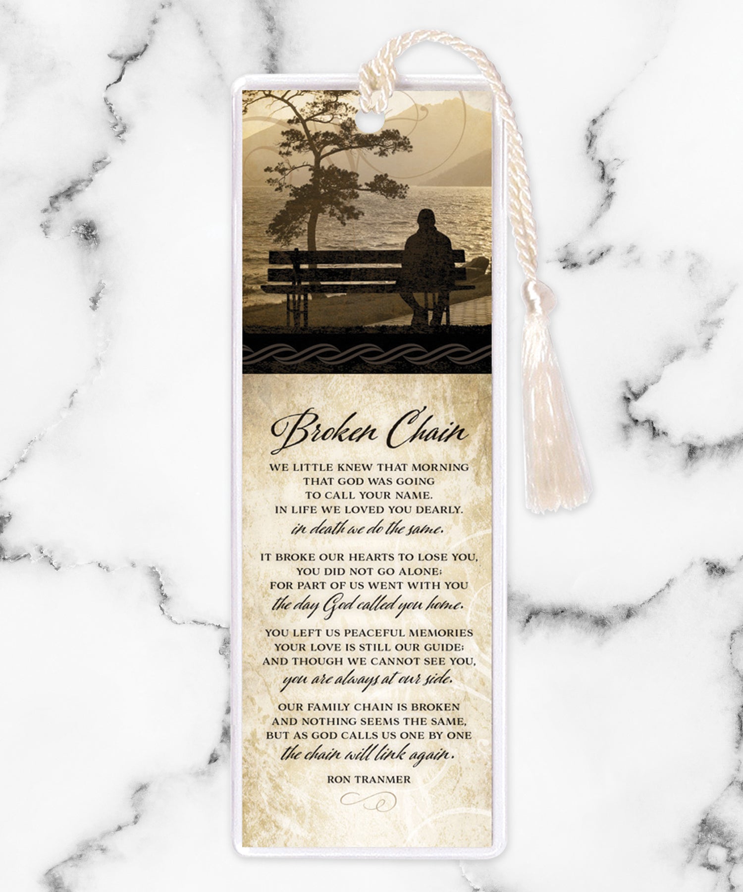 An elegant double-sided bookmark, Broken Chain, is protected by a clear vinyl sleeve and finished with a tassel.