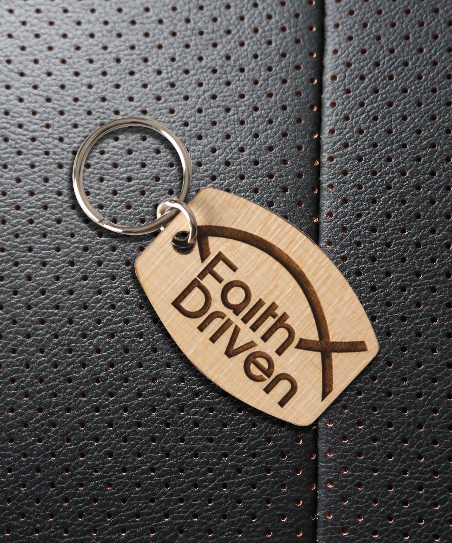 Natural maple wood keychains have a laser-cut shape and laser-engraved Faith Driven inspirational verse.