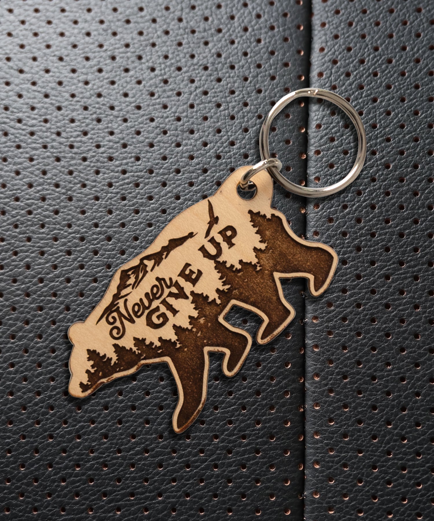 Natural maple wood keychains have a laser-cut shape and laser-engraved Never Give Up verse.