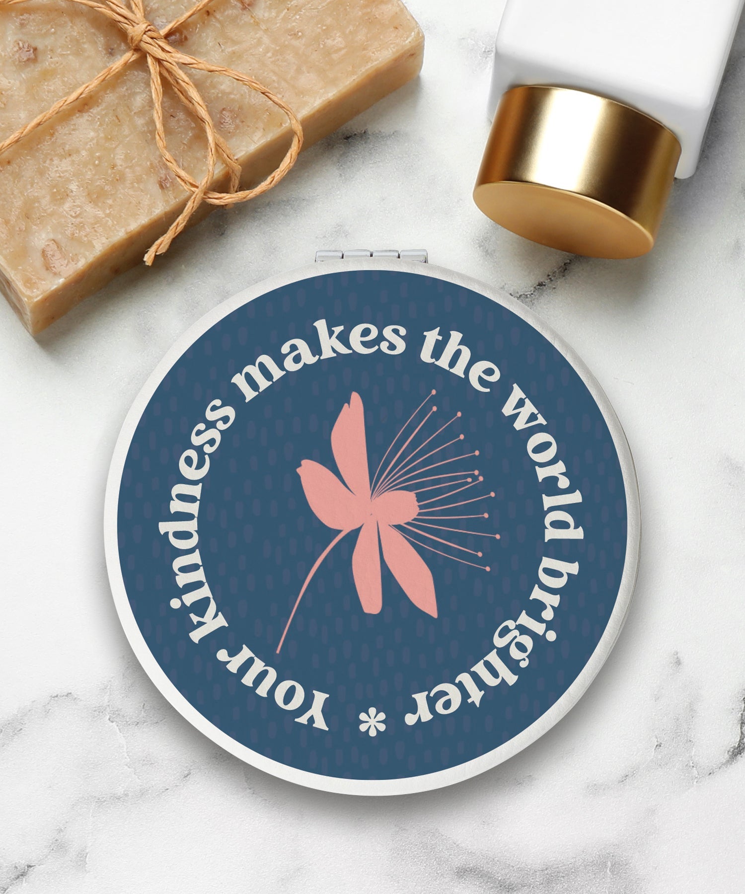 Round compact mirror with a leatherette cover, full-color “Your Kindness” design, 1X and 2X mirrors inside, and magnetic closure.
