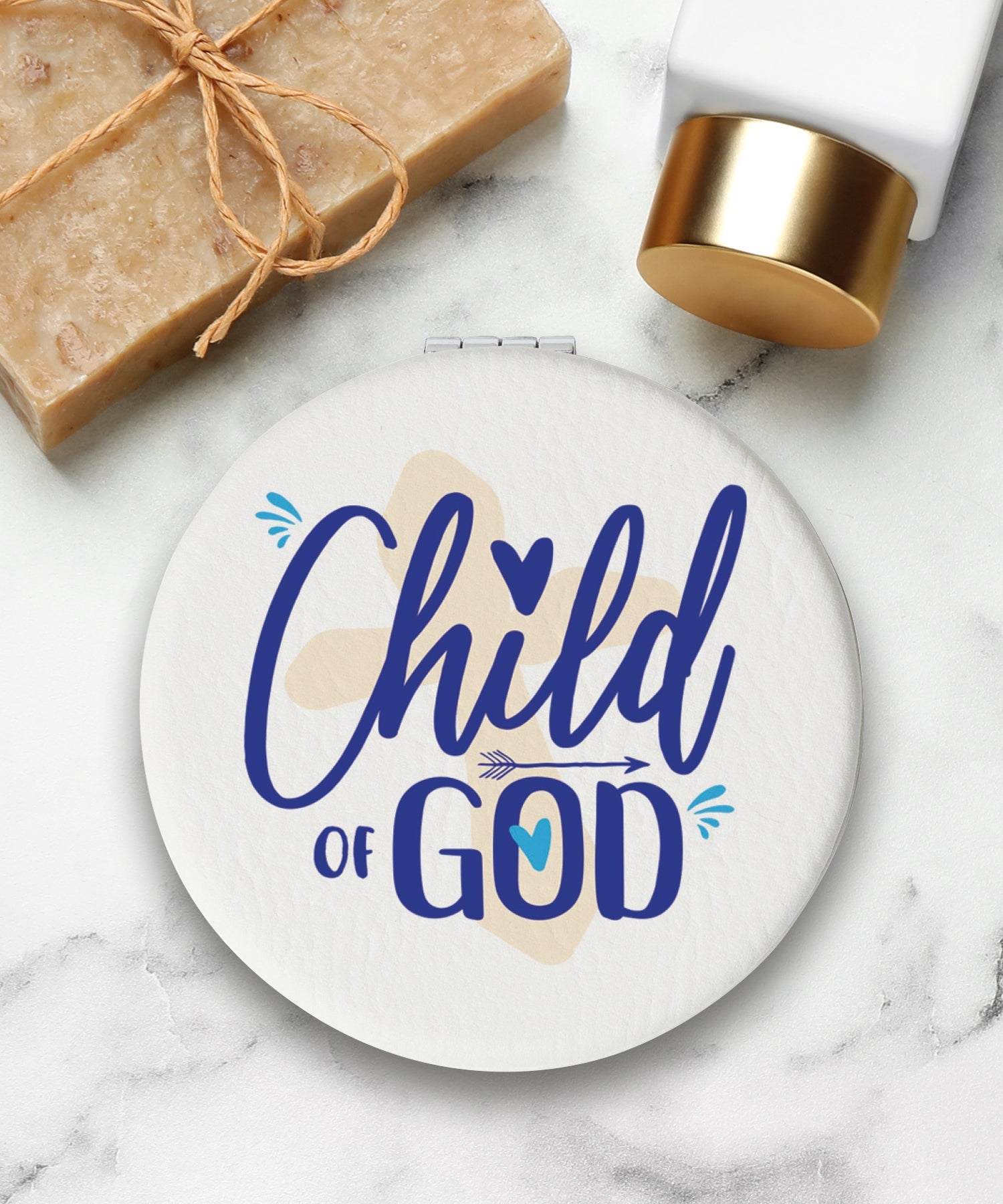 Round compact mirror with a leatherette cover, full-color “Child of God” design, 1X and 2X mirrors inside, and magnetic closure.