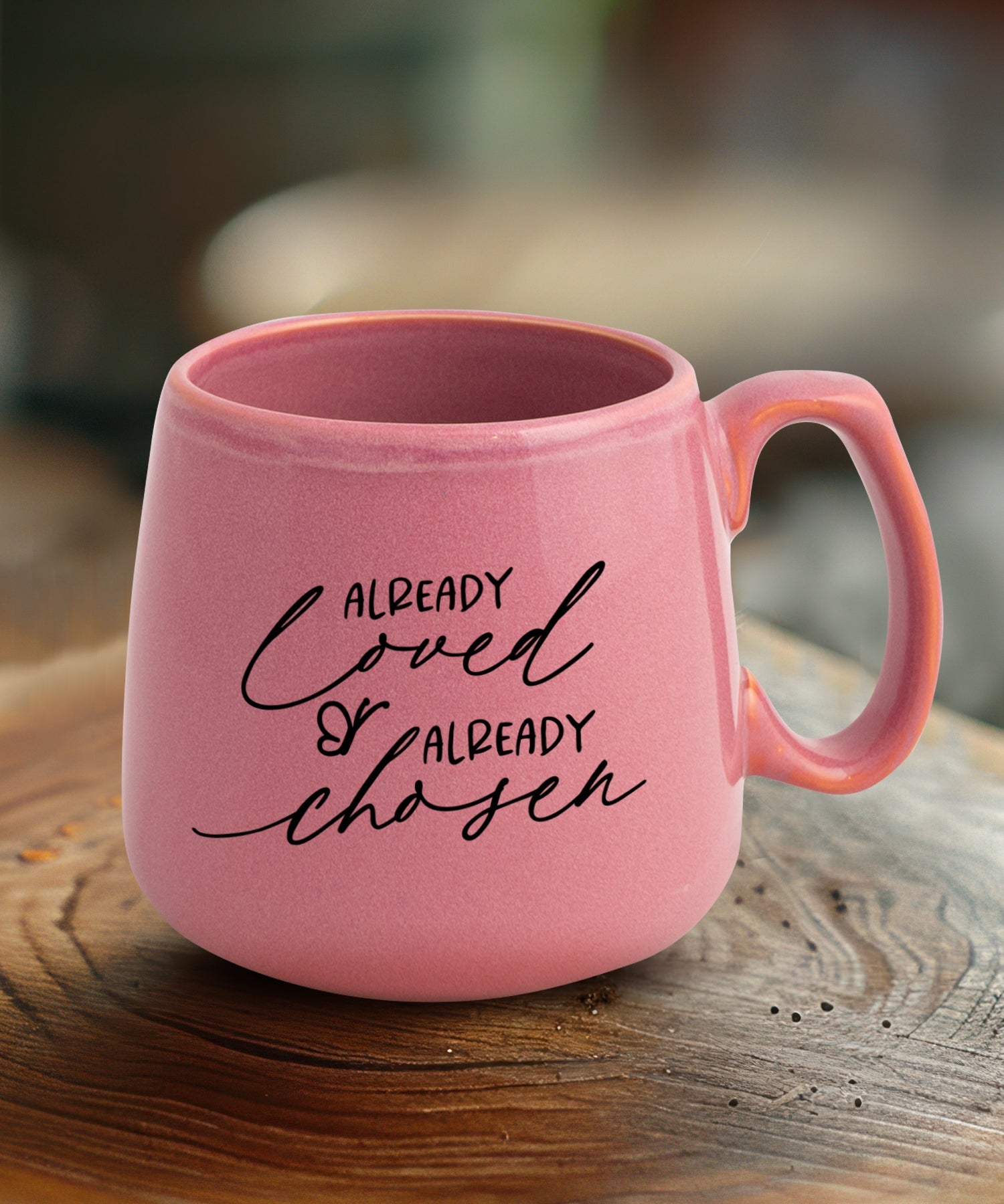 Ceramic mug with a broad base featuring Already Loved.