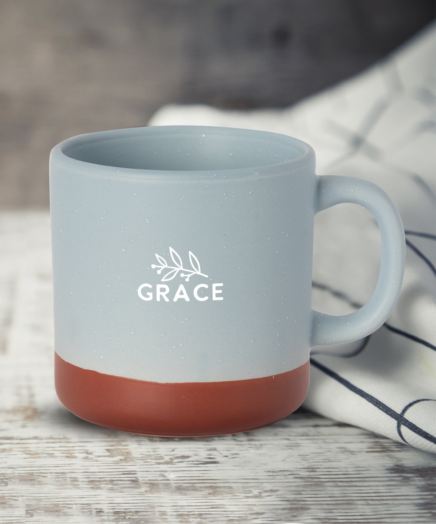 Grace Hearthside ceramic mug with speckled finish, natural baked bottom, and scripture message from II Corinthians 4:16, 14 oz