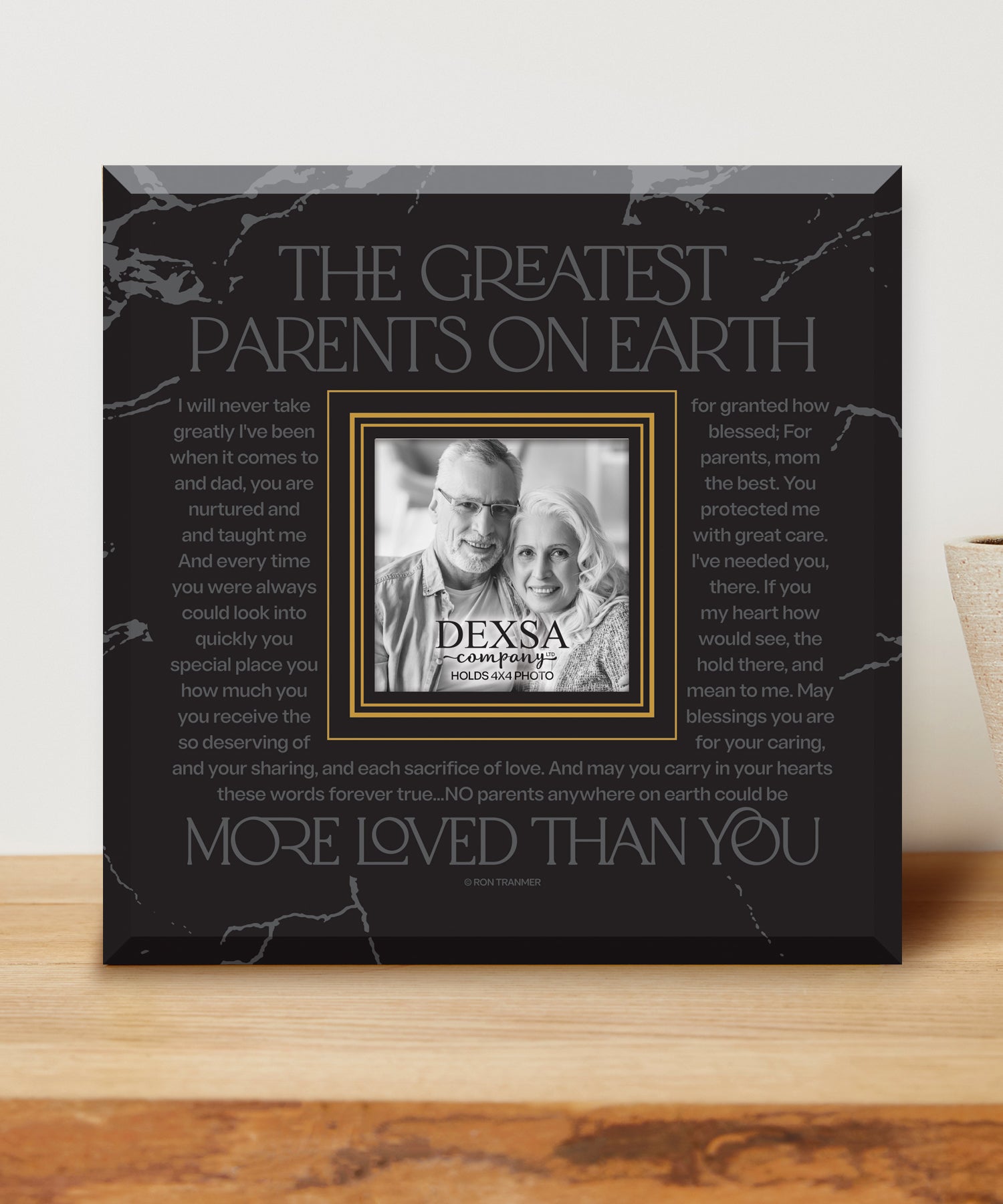 The Greatest Parents on Earth 12x12 Glass Photo Frame with smooth beveled edges, holding a 4x4 photo, displayed on a shelf.