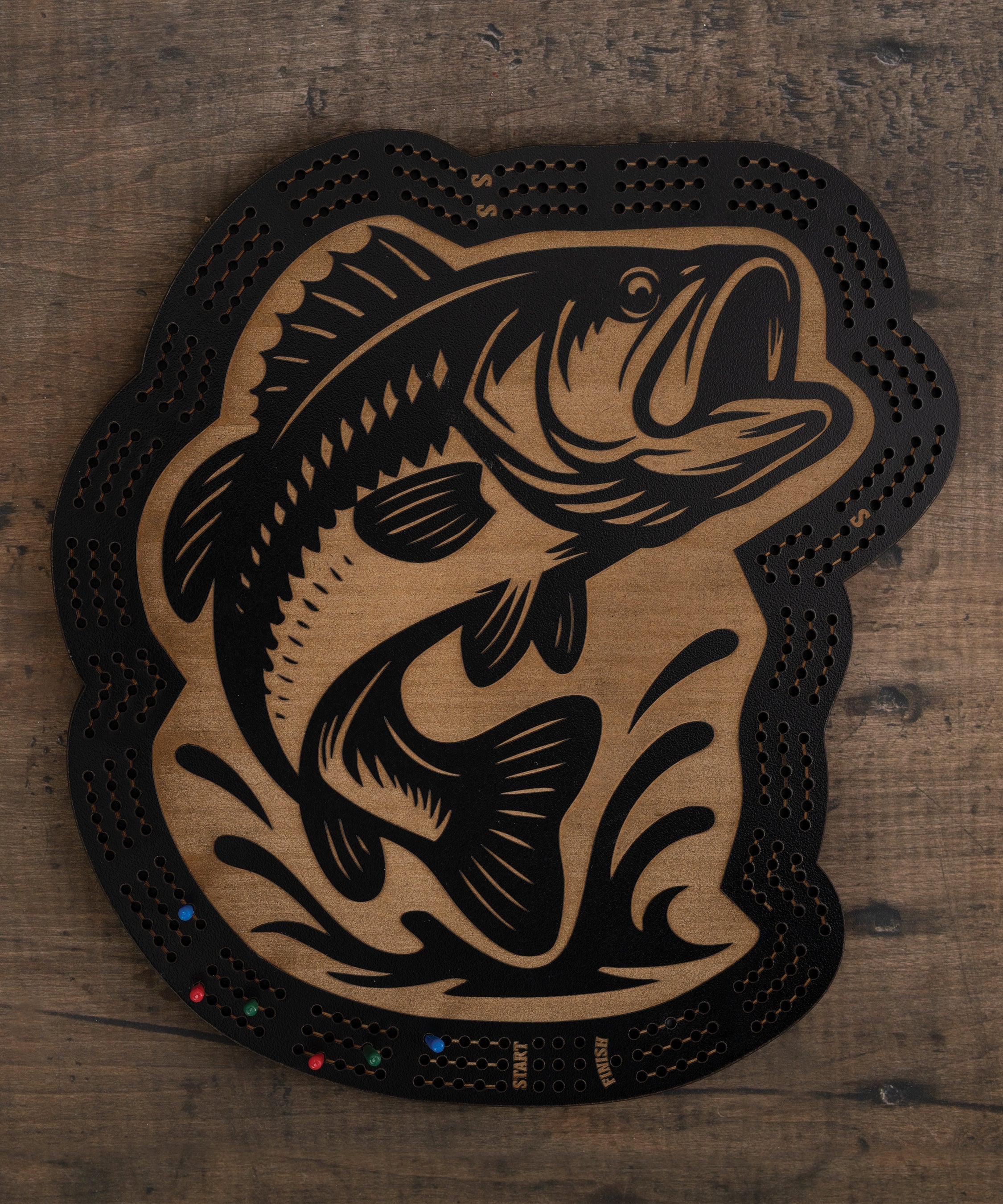 Bass cribbage board with black and brown fish artwork and built-in peg storage