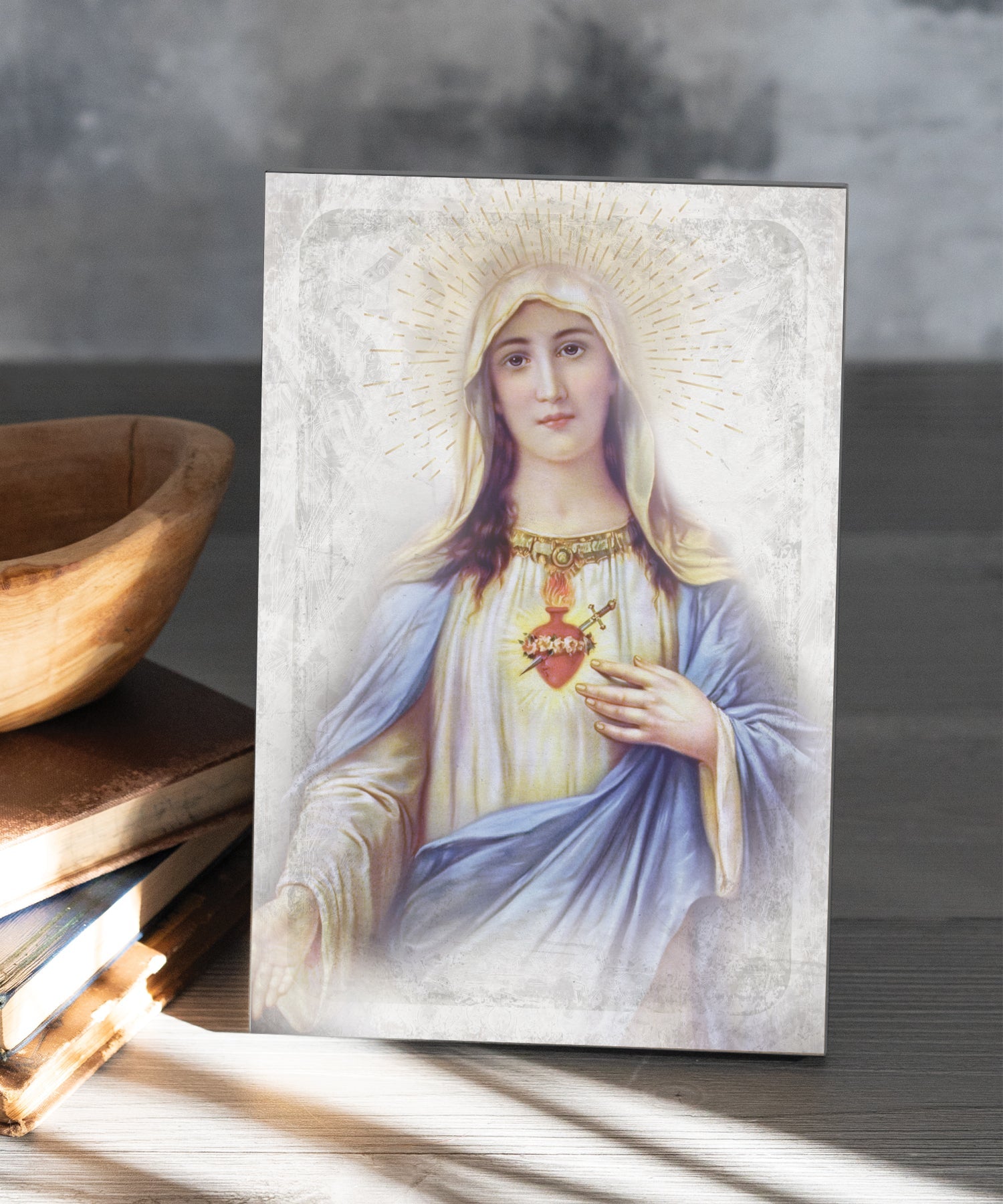 Immaculate Heart 6x9 MDF Plaque has natural edges, muted tones, and inspirational imagery reflecting our faith in God. The plaque features full-color printing and a metal hanger and easel back.