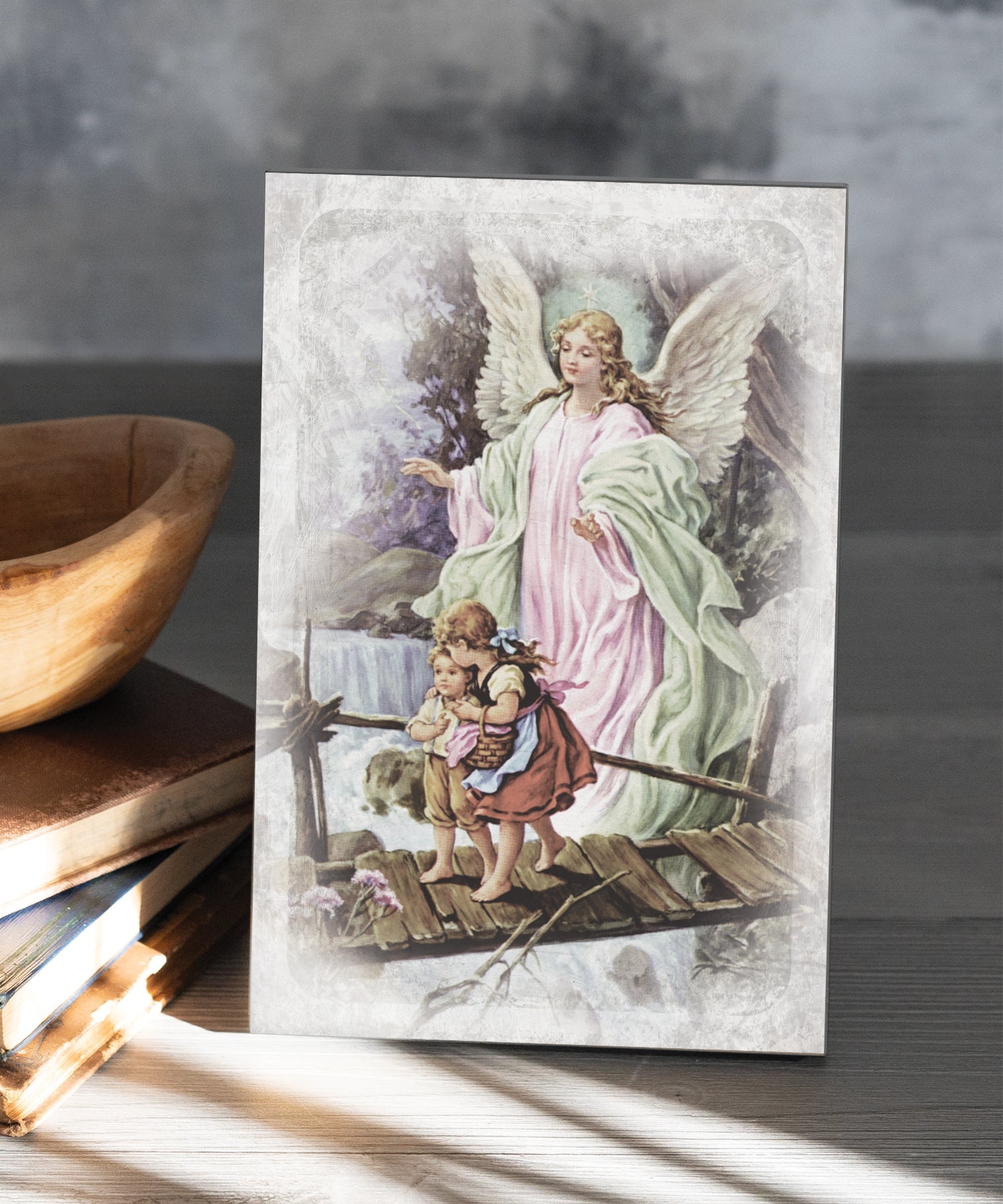 Guardian Angel 6x9 MDF Plaque has natural edges, muted tones, and inspirational imagery reflecting our faith in God. The plaque features full-color printing and a metal hanger and easel back.
