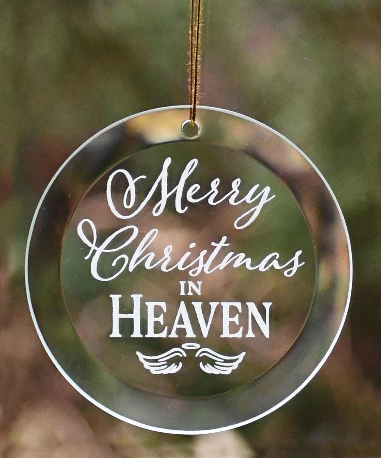 Merry Christmas in Heaven glass ornament with laser-etched design, suspended by a gold-colored string