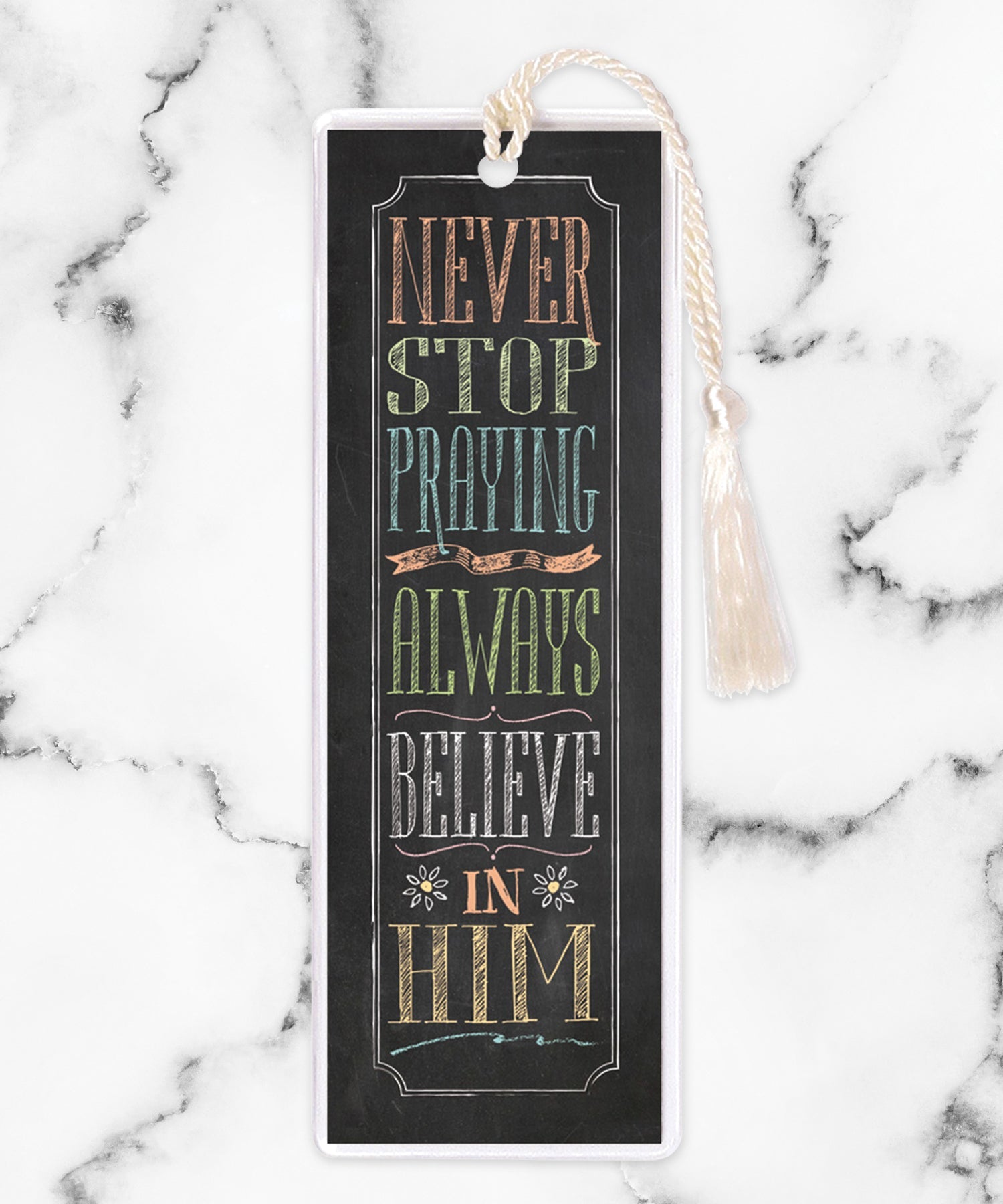 An elegant double-sided bookmark, Never Stop Praying, is protected by a clear vinyl sleeve and finished with a tassel.