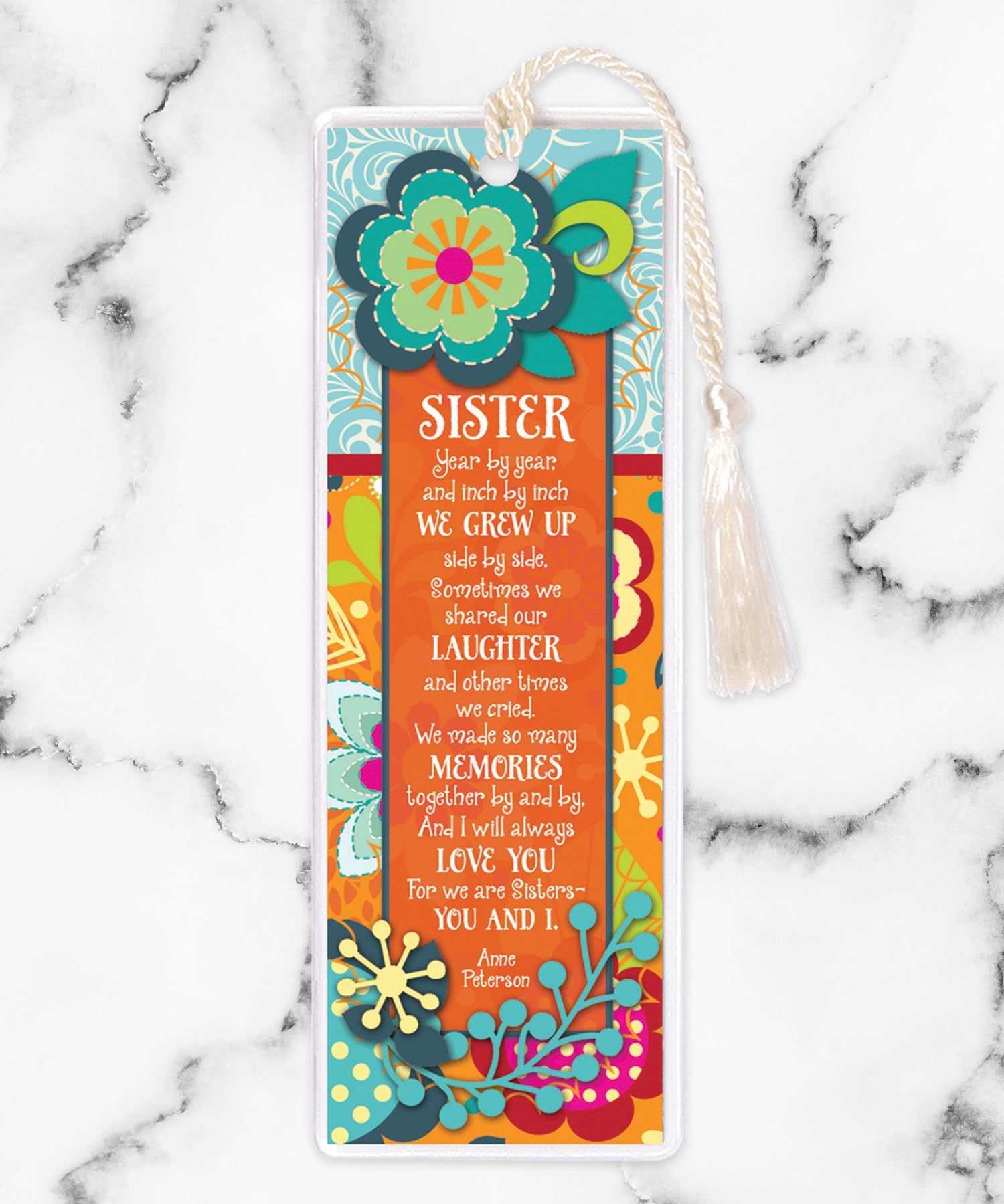 An elegant double-sided bookmark, Sister, is protected by a clear vinyl sleeve and finished with a tassel.