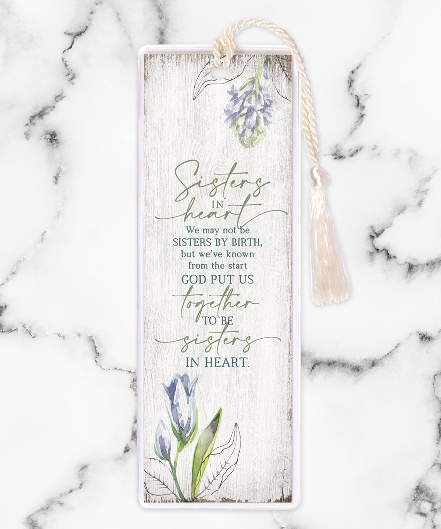 An elegant double-sided bookmark, Sisters In Heart, is protected by a clear vinyl sleeve and finished with a tassel.