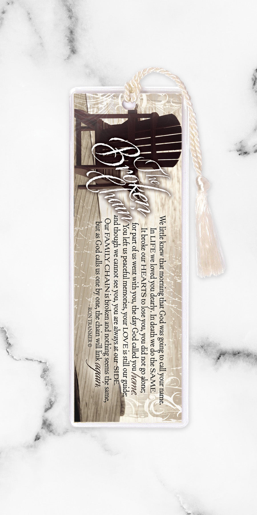 An elegant double-sided bookmark, Broken Chain, is protected by a clear vinyl sleeve and finished with a tassel.