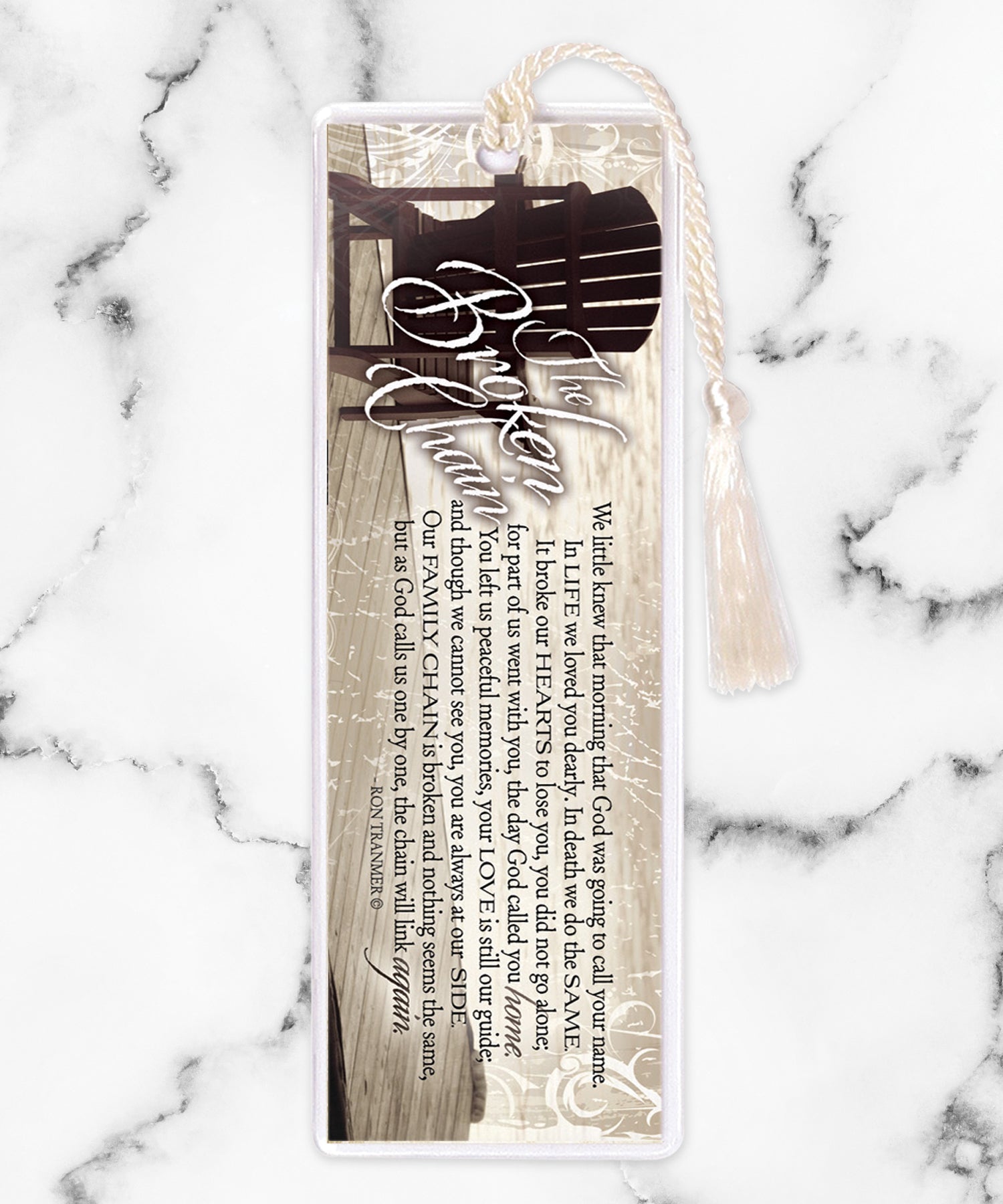 An elegant double-sided bookmark, Broken Chain, is protected by a clear vinyl sleeve and finished with a tassel.
