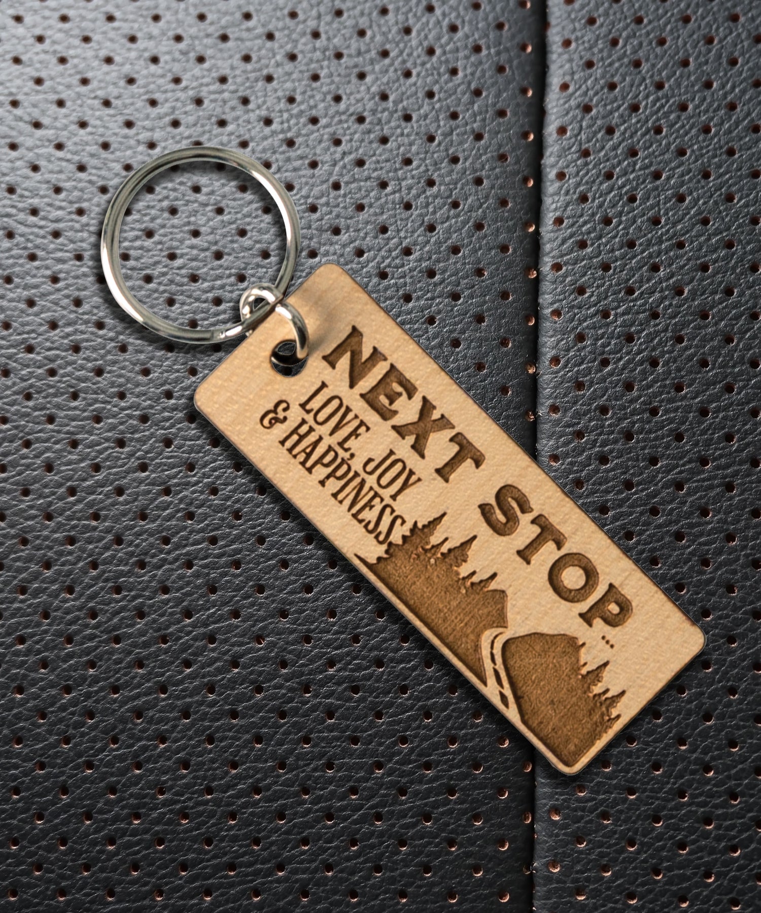 Natural maple wood keychains have a laser-cut shape and laser-engraved Next Stop inspirational verse.