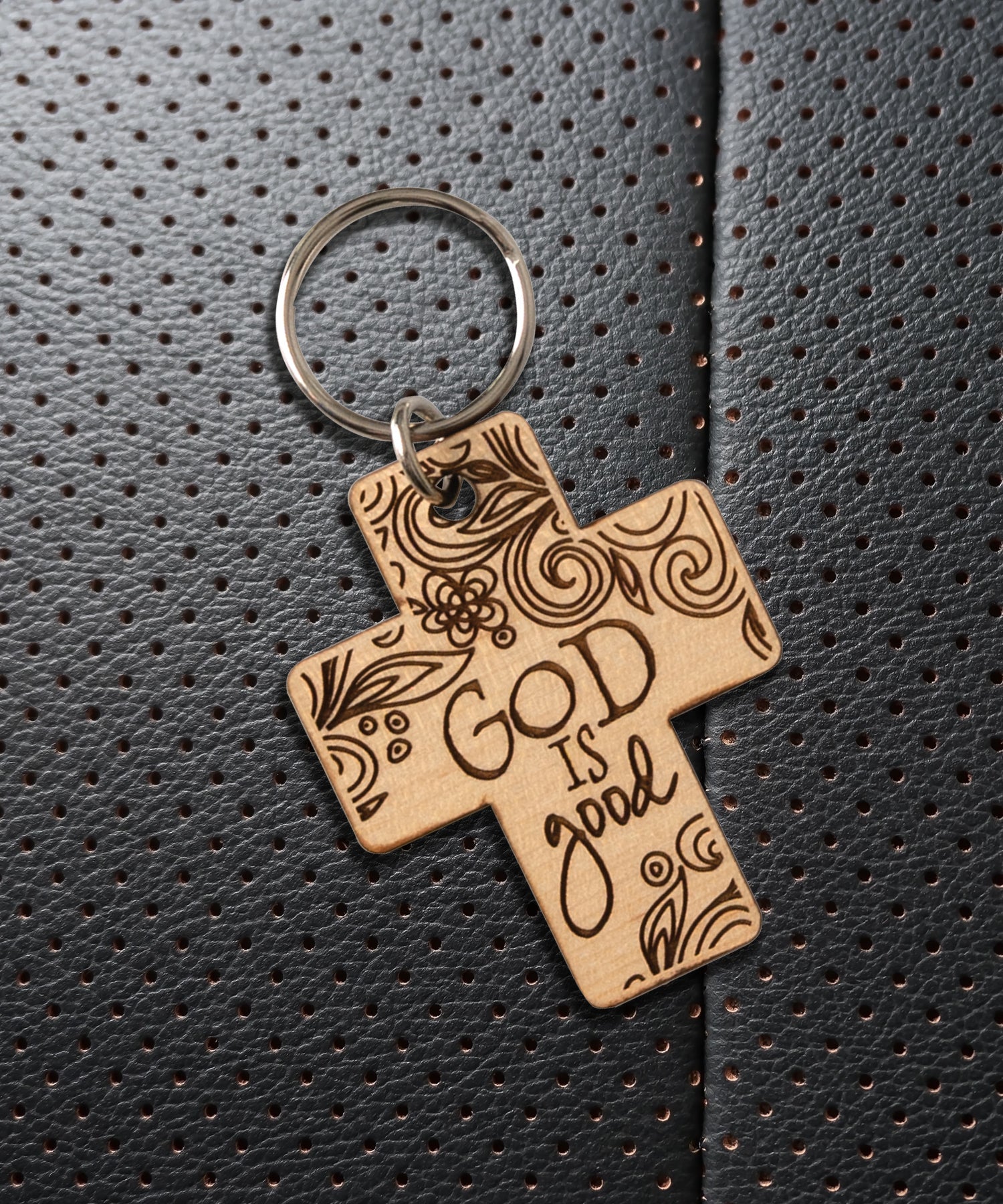 Natural maple wood keychains have a laser-cut shape and laser-engraved God is Good inspirational verse.