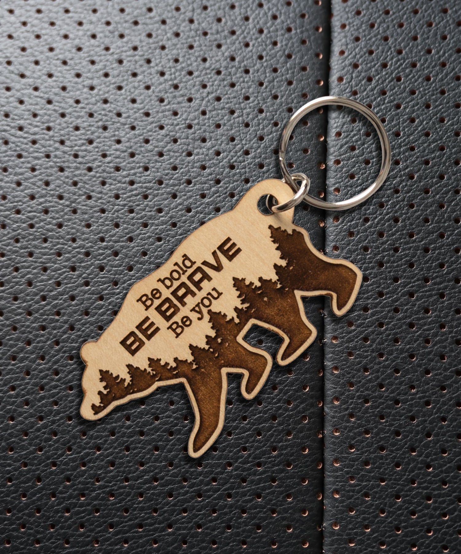 Natural maple wood keychains have a laser-cut shape and laser-engraved Be Bold Be Brave inspirational verse.