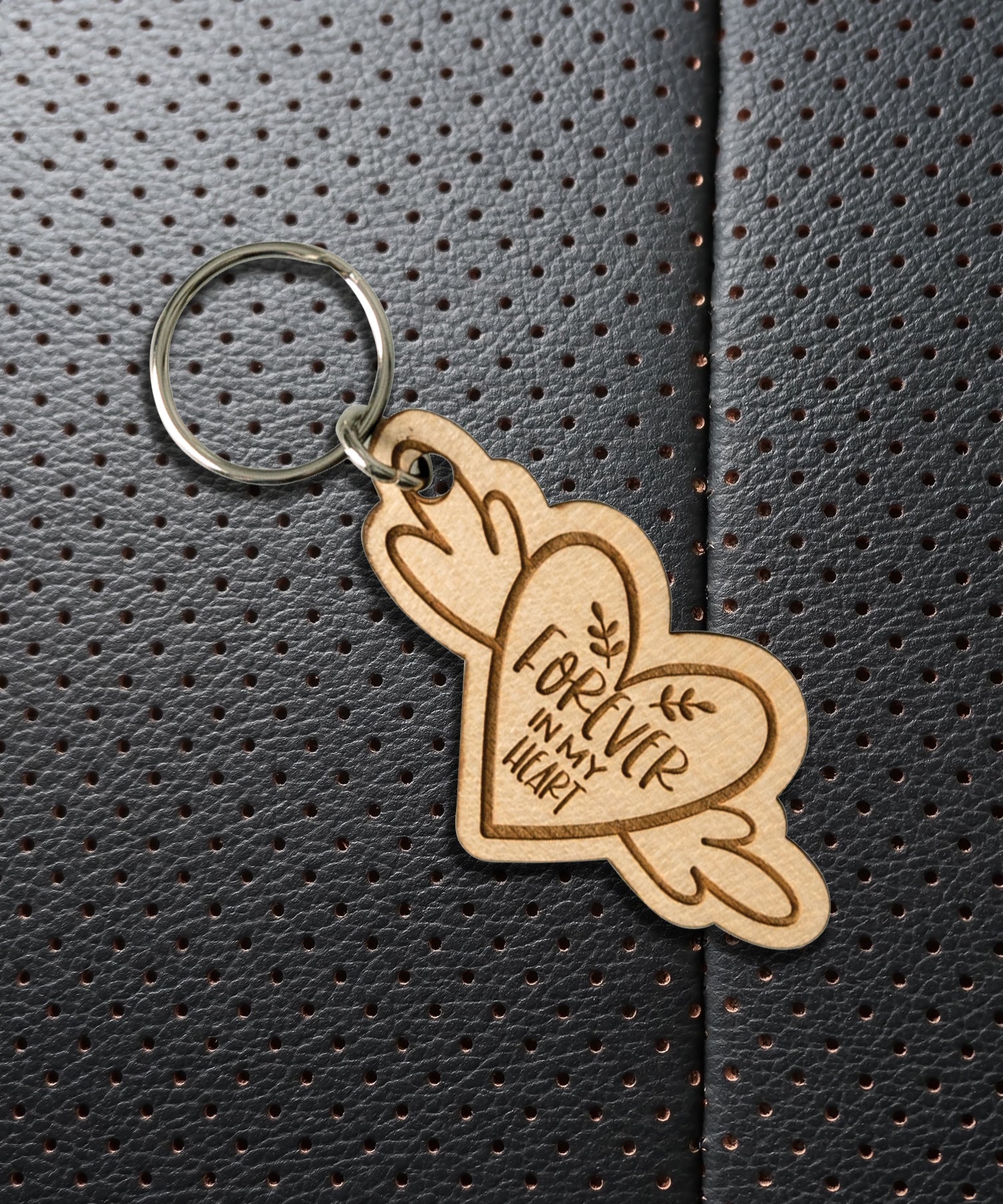 Natural maple wood keychains have a laser-cut shape and laser-engraved Forever in My Heart inspirational verse.