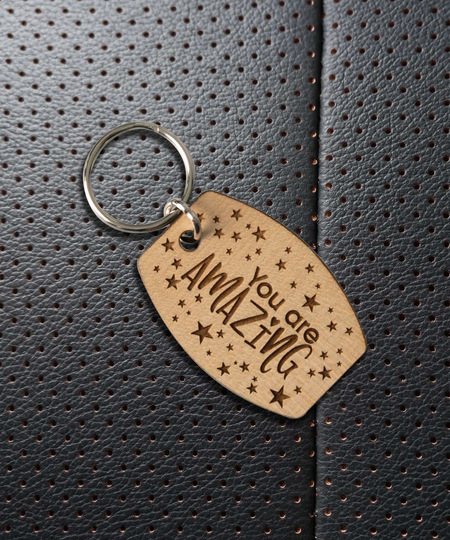 Natural maple wood keychains have a laser-cut shape and laser-engraved You Are Amazing inspirational verse.