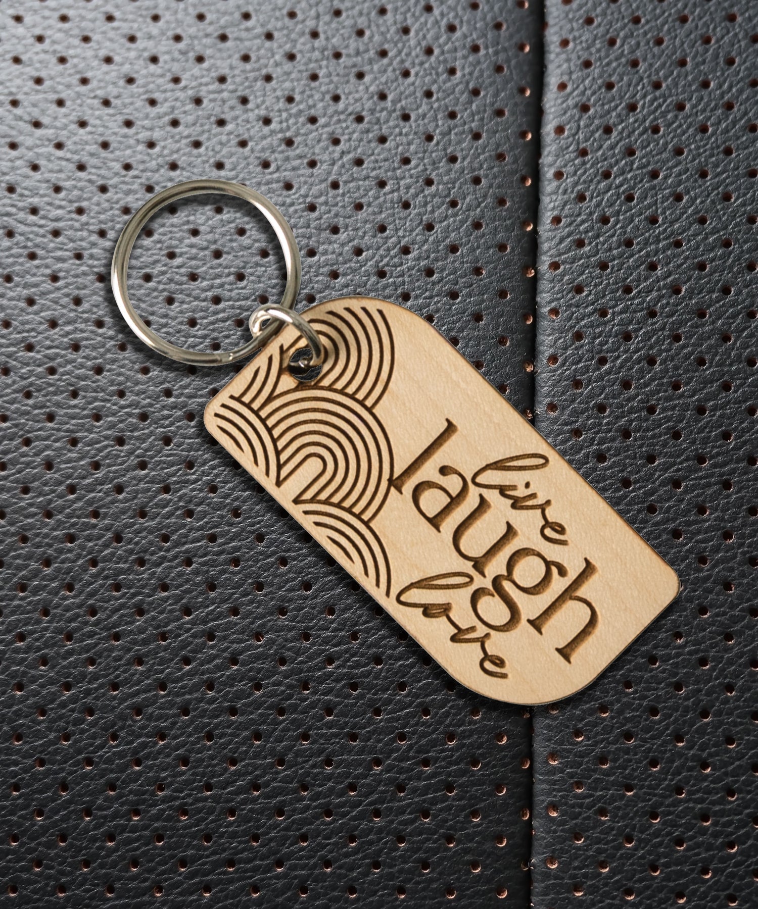 Natural maple wood keychains have a laser-cut shape and laser-engraved Live Laugh Love inspirational verse.