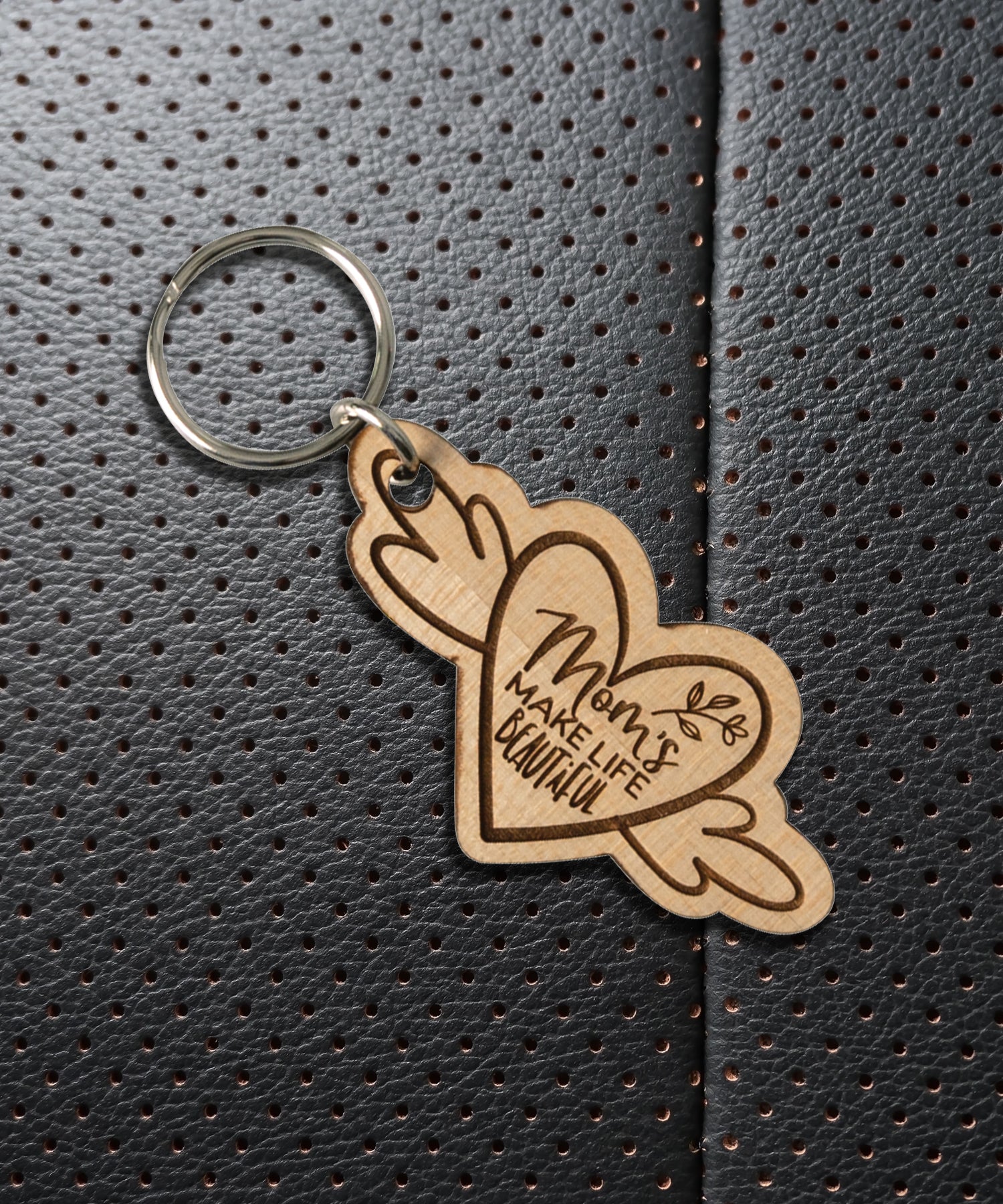 Natural maple wood keychains have a laser-cut shape and laser-engraved Mom's Make Life inspirational verse.