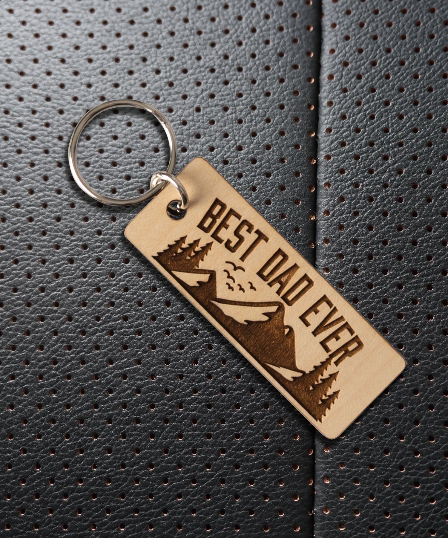 Natural maple wood keychains have a laser-cut shape and laser-engraved Best Dad Ever verse.