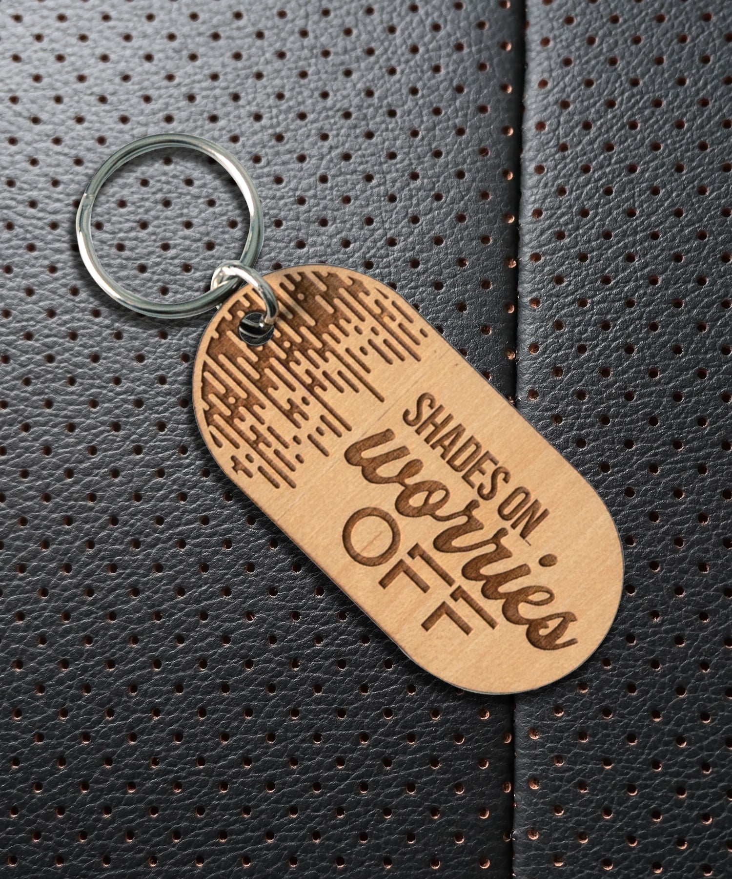Natural maple wood keychains have a laser-cut shape and laser-engraved Shades On Worries Off verse.