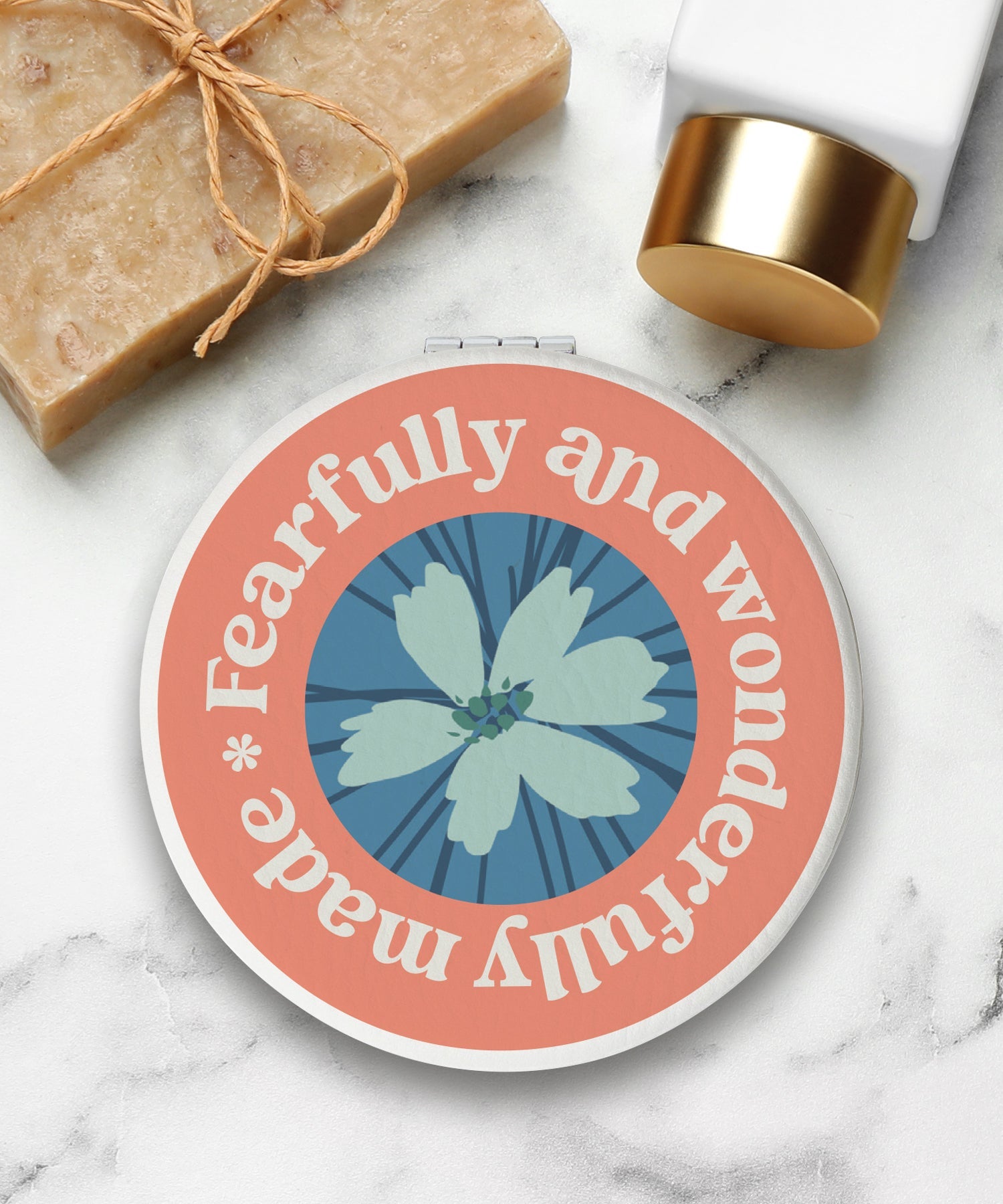 Round compact mirror with a leatherette cover, full-color “Fearfully and Wonderfully Made” design, 1X and 2X mirrors inside, and magnetic closure.