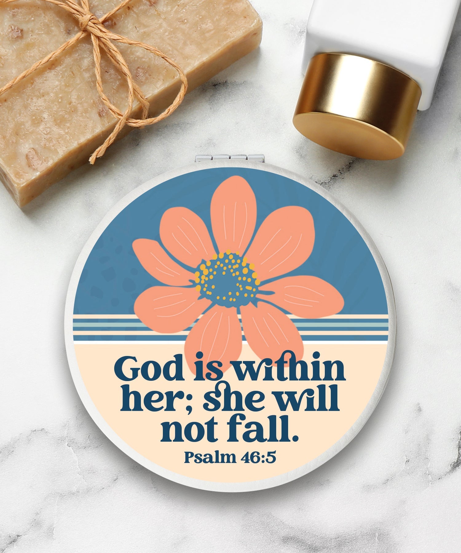 Round compact mirror with a leatherette cover, full-color “God Is Within Her” design, 1X and 2X mirrors inside, and magnetic closure.