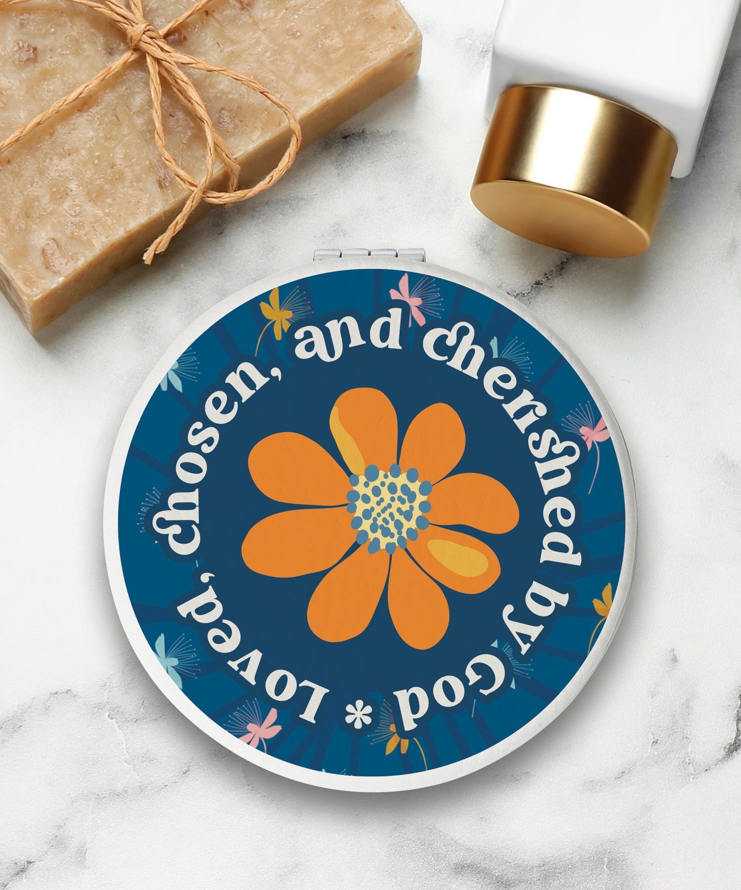 Round compact mirror with a leatherette cover, full-color “Loved Chosen Cherished” design, 1X and 2X mirrors inside, and magnetic closure.