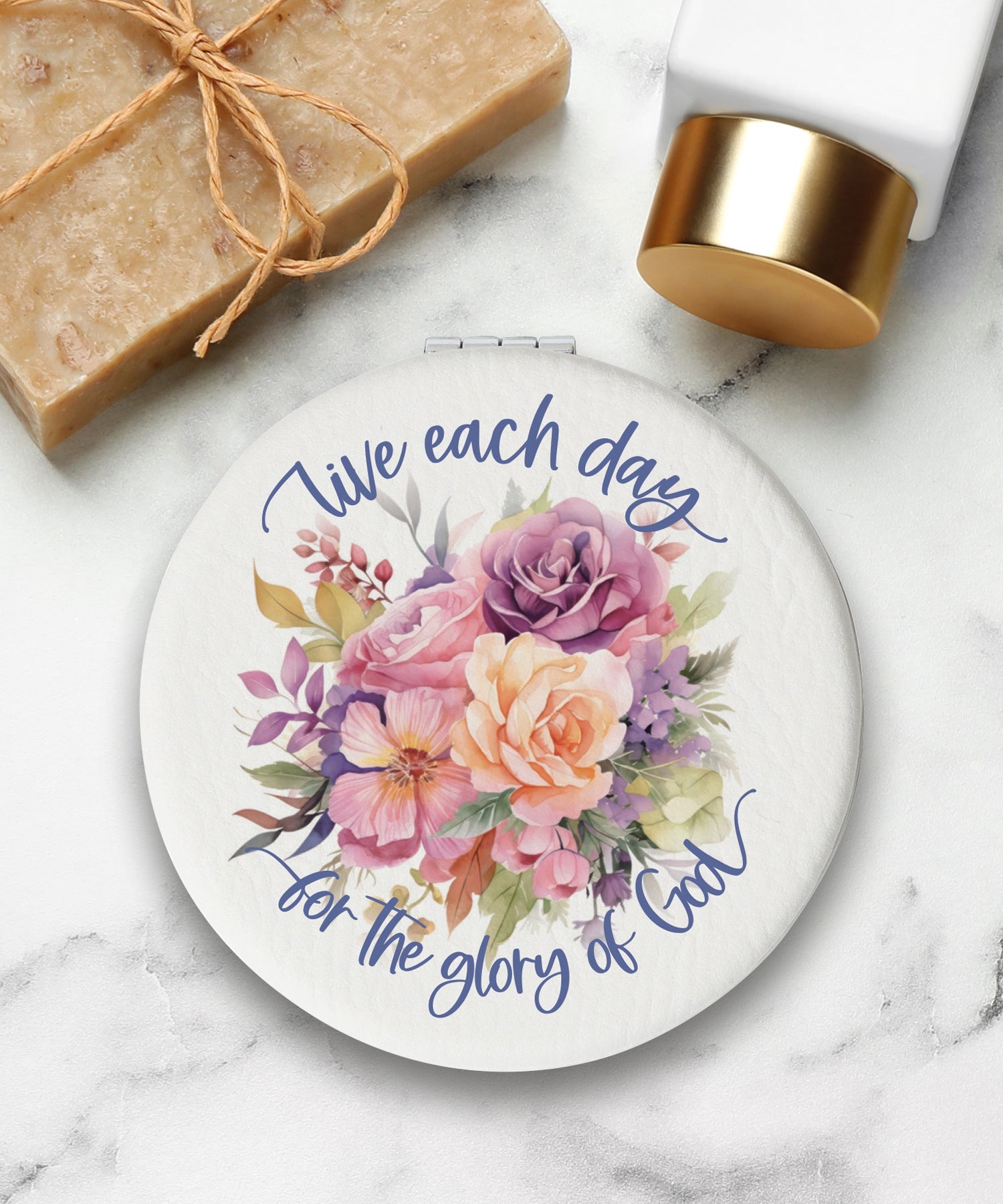 Round compact mirror with a leatherette cover, full-color “Live Each Day” design, 1X and 2X mirrors inside, and magnetic closure.