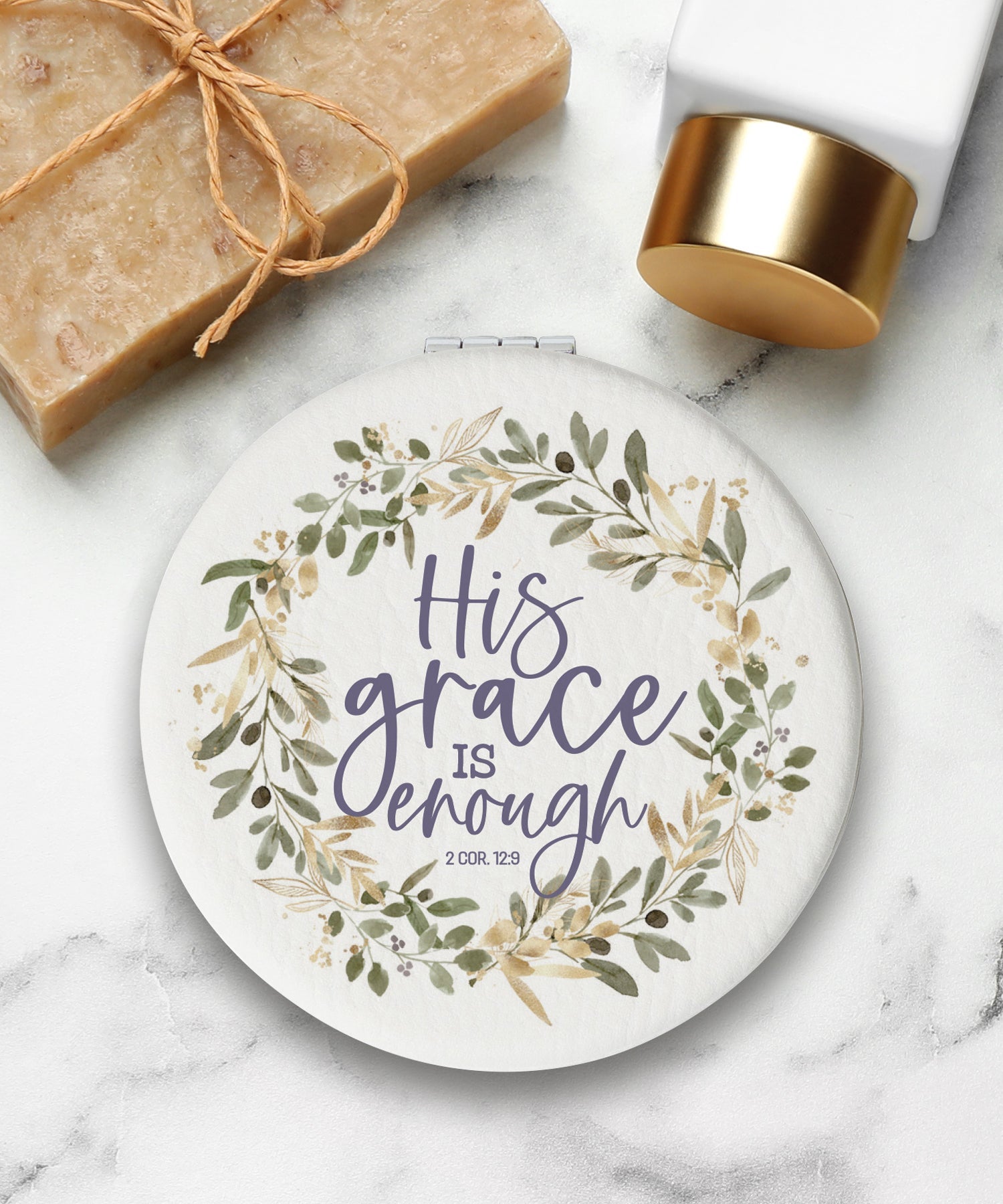 Round compact mirror with a leatherette cover, full-color “His Grace Is Enough” design, 1X and 2X mirrors inside, and magnetic closure.