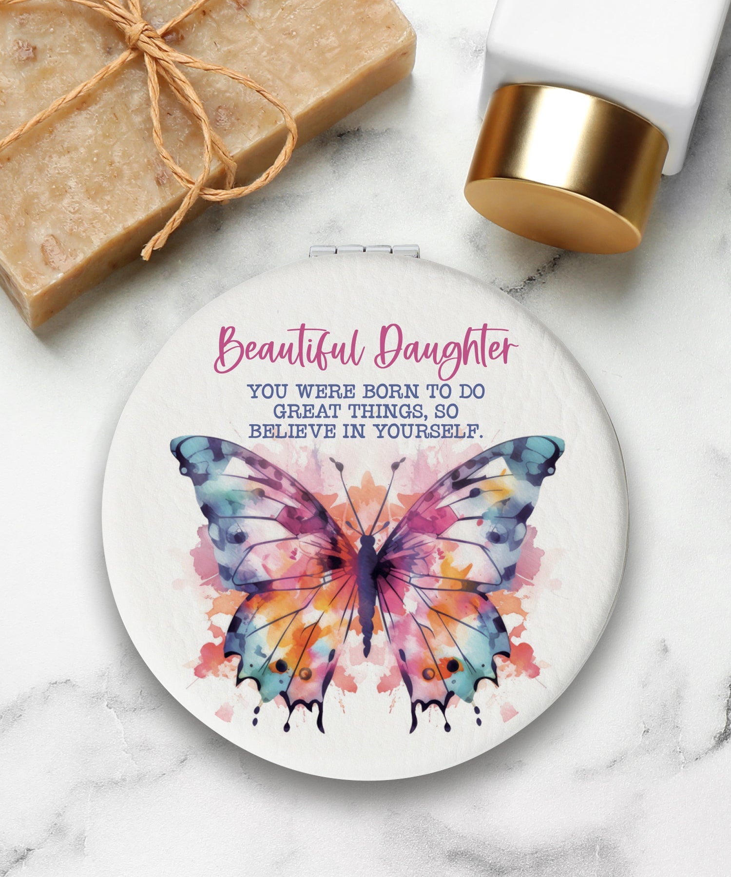 Round compact mirror with a leatherette cover, full-color “Beautiful Daughter” design, 1X and 2X mirrors inside, and magnetic closure.
