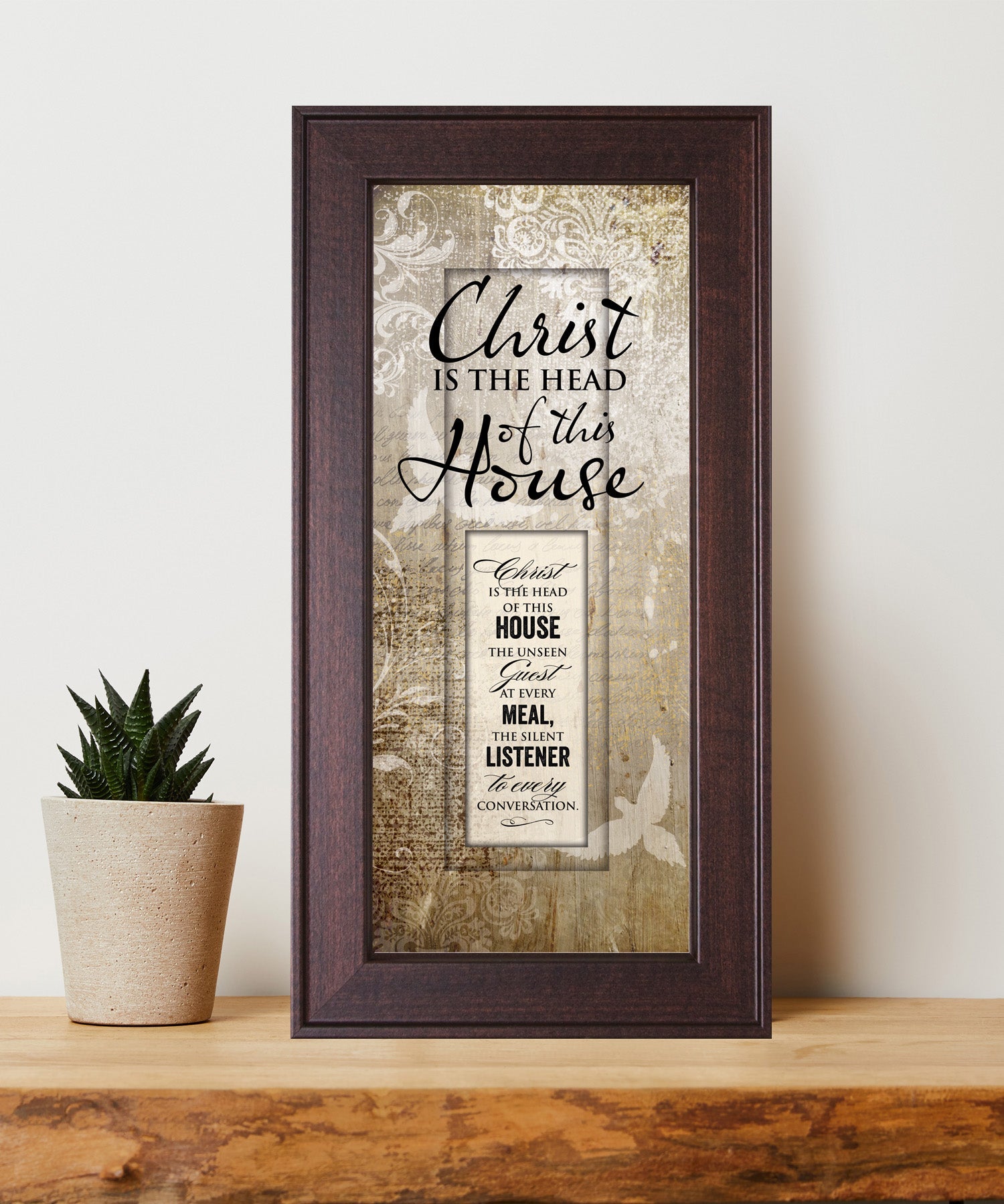 Christ Is the Head Framed Art with the inspirational quote is displayed prominently. The design includes elegant typography on a textured background, framed in a classic wood frame with a sophisticated finish.
