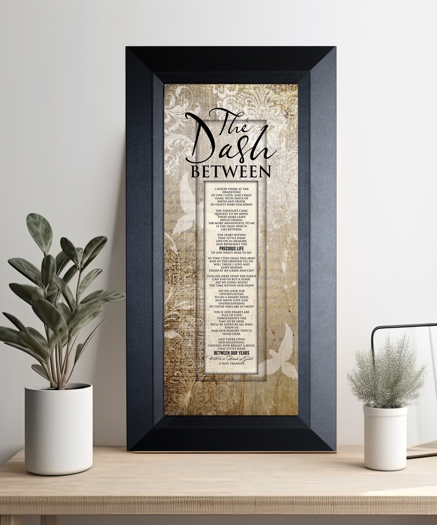 The Dash Between Framed Art with the inspirational poem is displayed prominently. The design includes elegant typography on a textured background, framed in a classic wood frame with a sophisticated finish.