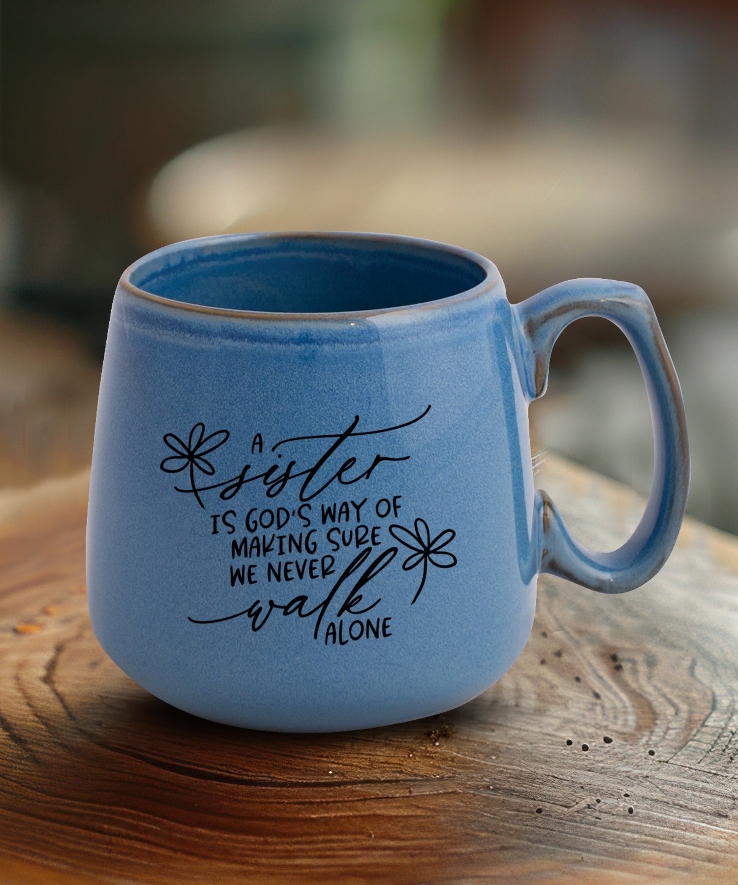 Ceramic mug with a broad base featuring A Sister.