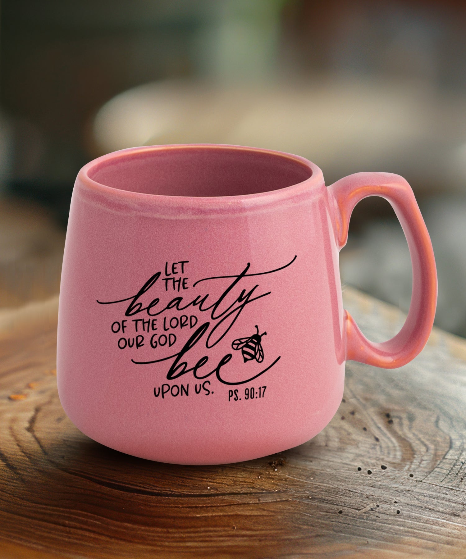 Ceramic mug with a broad base featuring Let the Beauty.