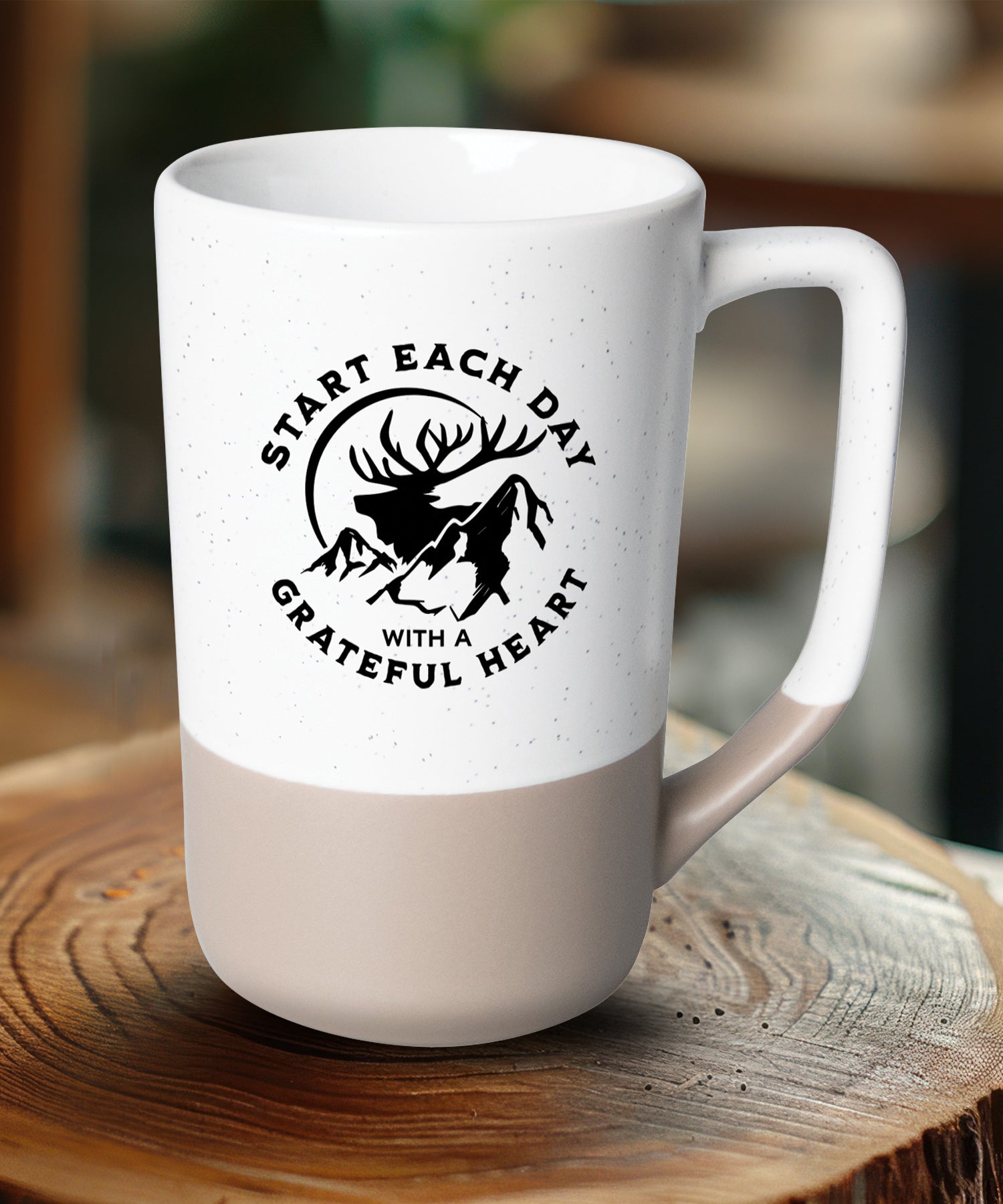 Two-toned ceramic mug with pebble accents featuring Start Each Day and a corresponding image.
