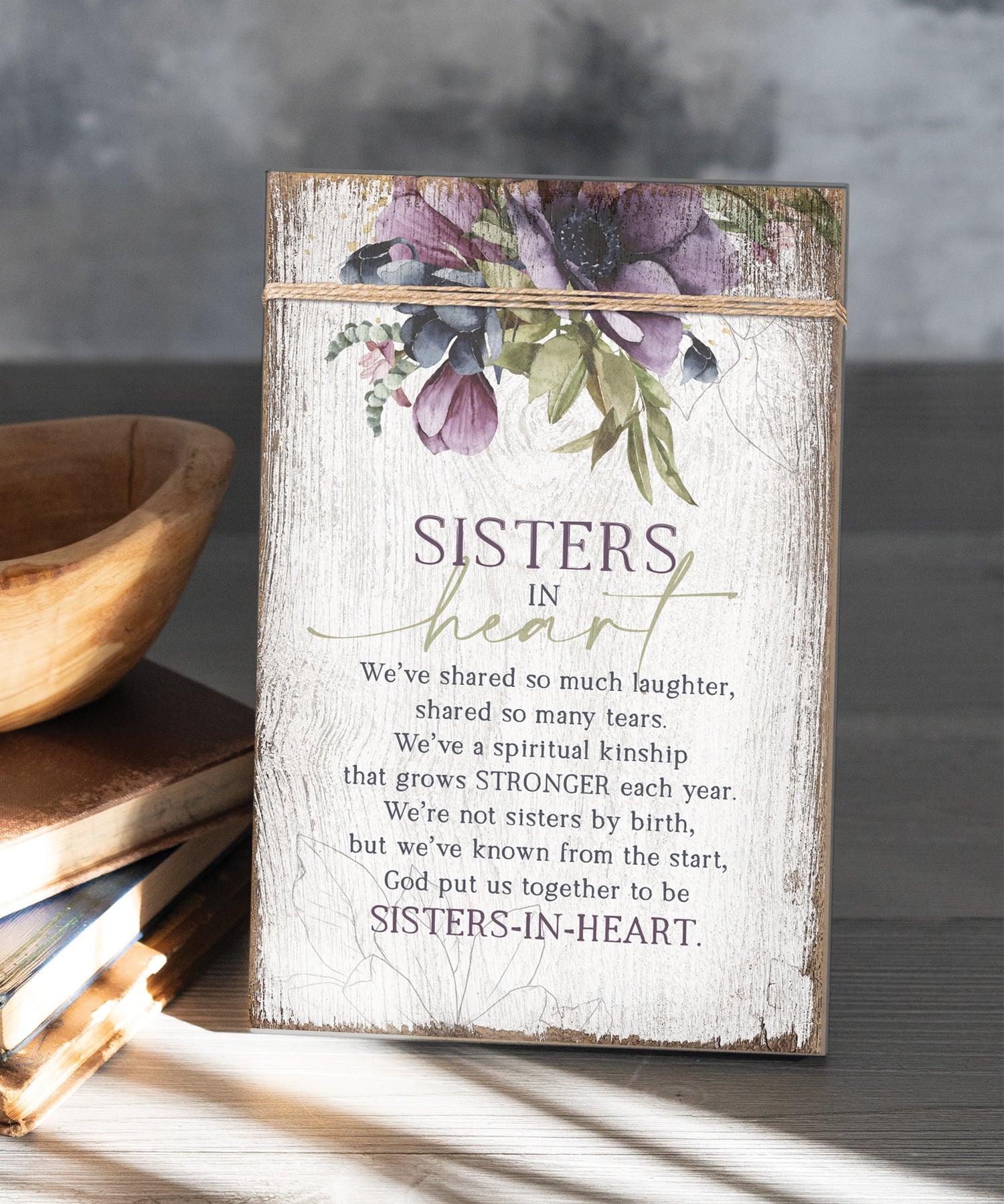 Sisters in Heart 6x9 MDF Plaque wrapped with twine for a modern farmhouse look. It features full-color printing and a keyhole for easy hanging.