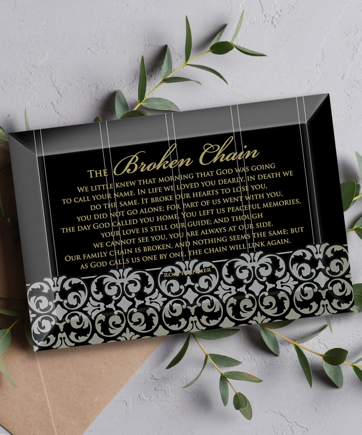 Broken Chain Glass Plaque, which has smooth beveled edges and a screen-printed design, is perfect for display on a shelf.