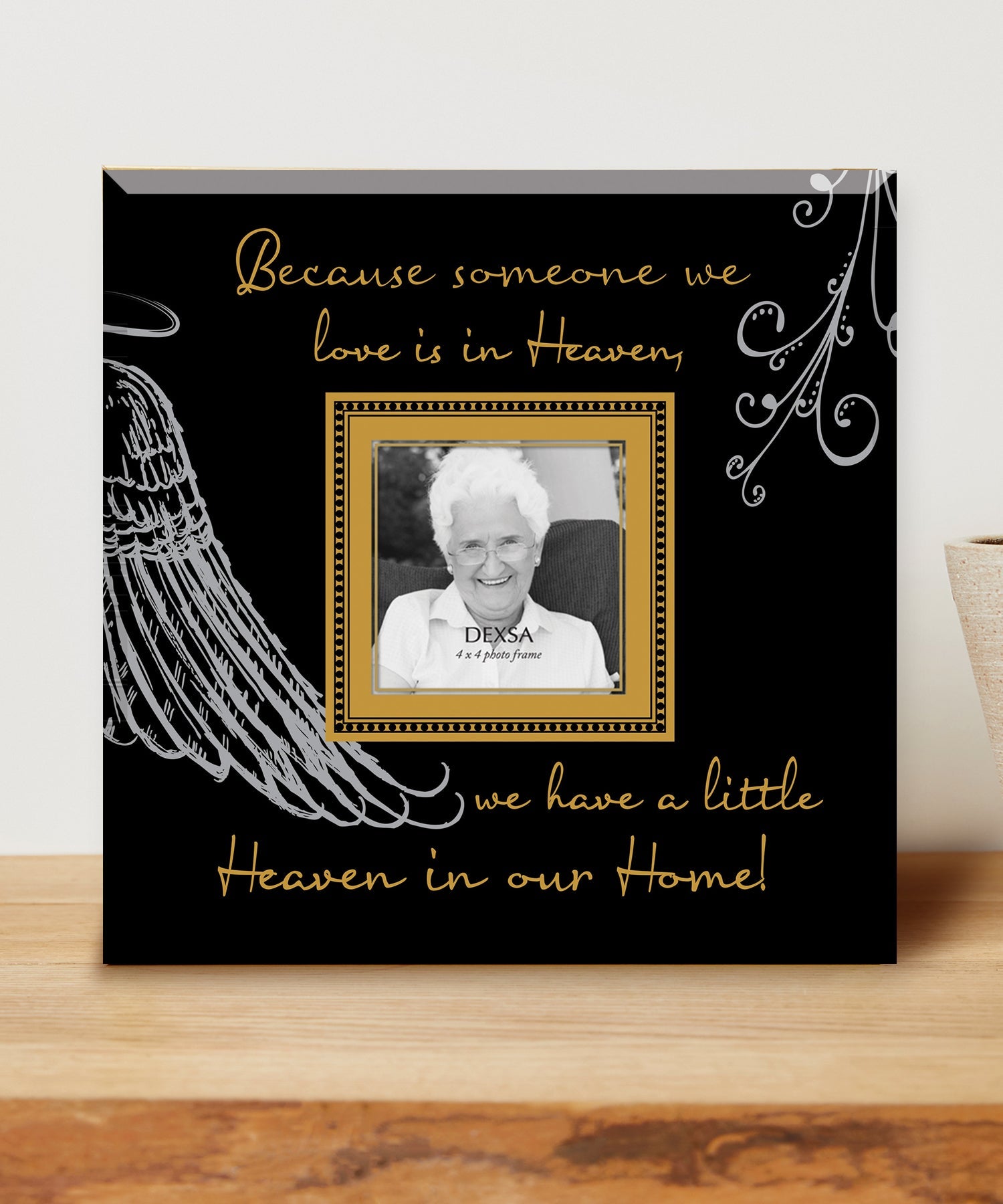 Because Someone We Love Glass Photo Frame with smooth beveled edges, holding a 4x4 photo, displayed on a shelf.