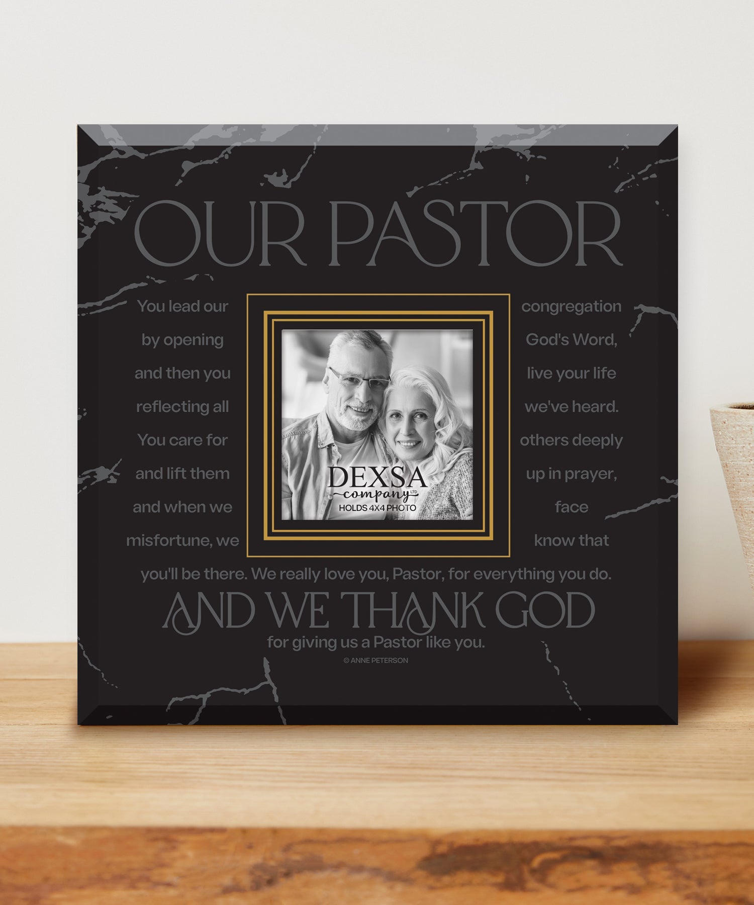 Our Pastor 12x12 Glass Photo Frame with smooth beveled edges, holding a 4x4 photo, displayed on a shelf.