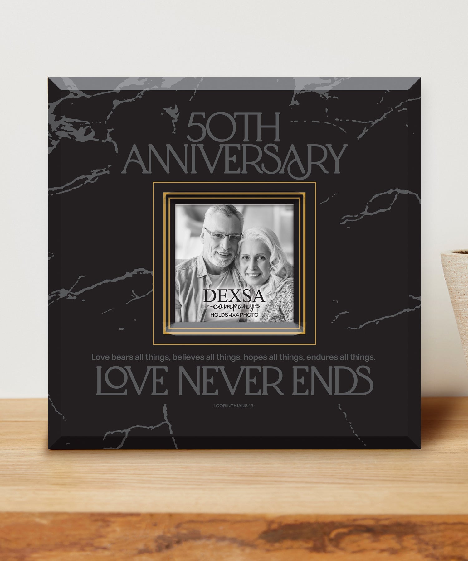 50th Anniversary 12x12 Glass Photo Frame with smooth beveled edges, holding a 4x4 photo, displayed on a shelf.