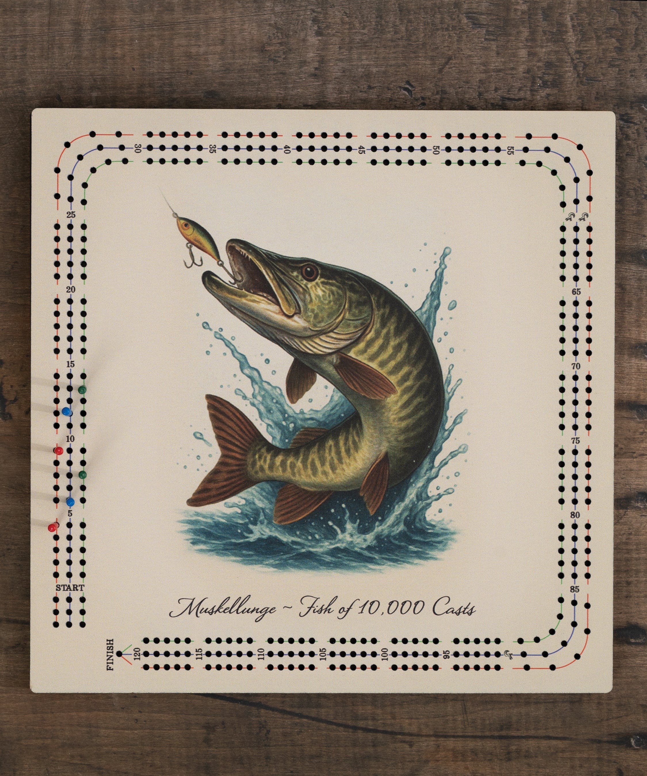 Muskellunge cribbage board with detailed muskie artwork and “Fish of 10,000 Casts” theme, built-in peg storage