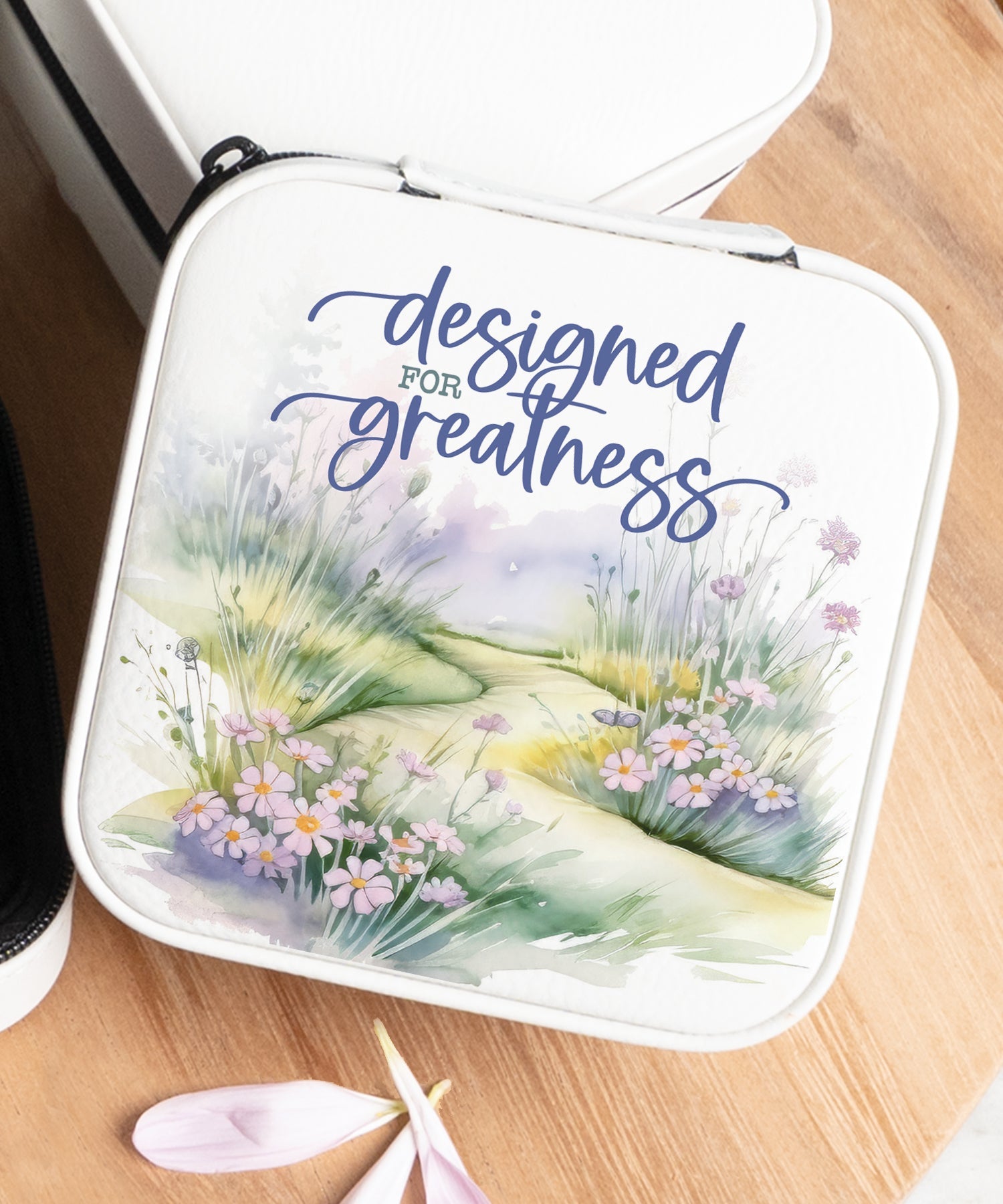 Designed for Greatness Travel Jewelry Case in off-white leatherette with a zipper closure and plush black velvet interior.