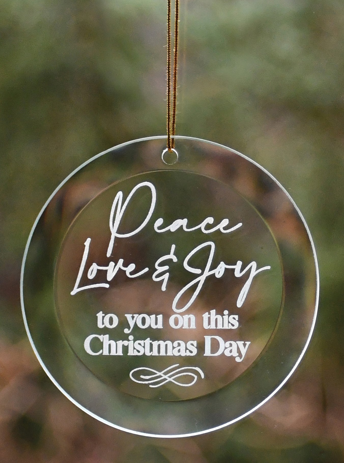 Peace Love Joy Glass Ornament with laser-etched design and gold string hanger, perfect for Christmas décor
